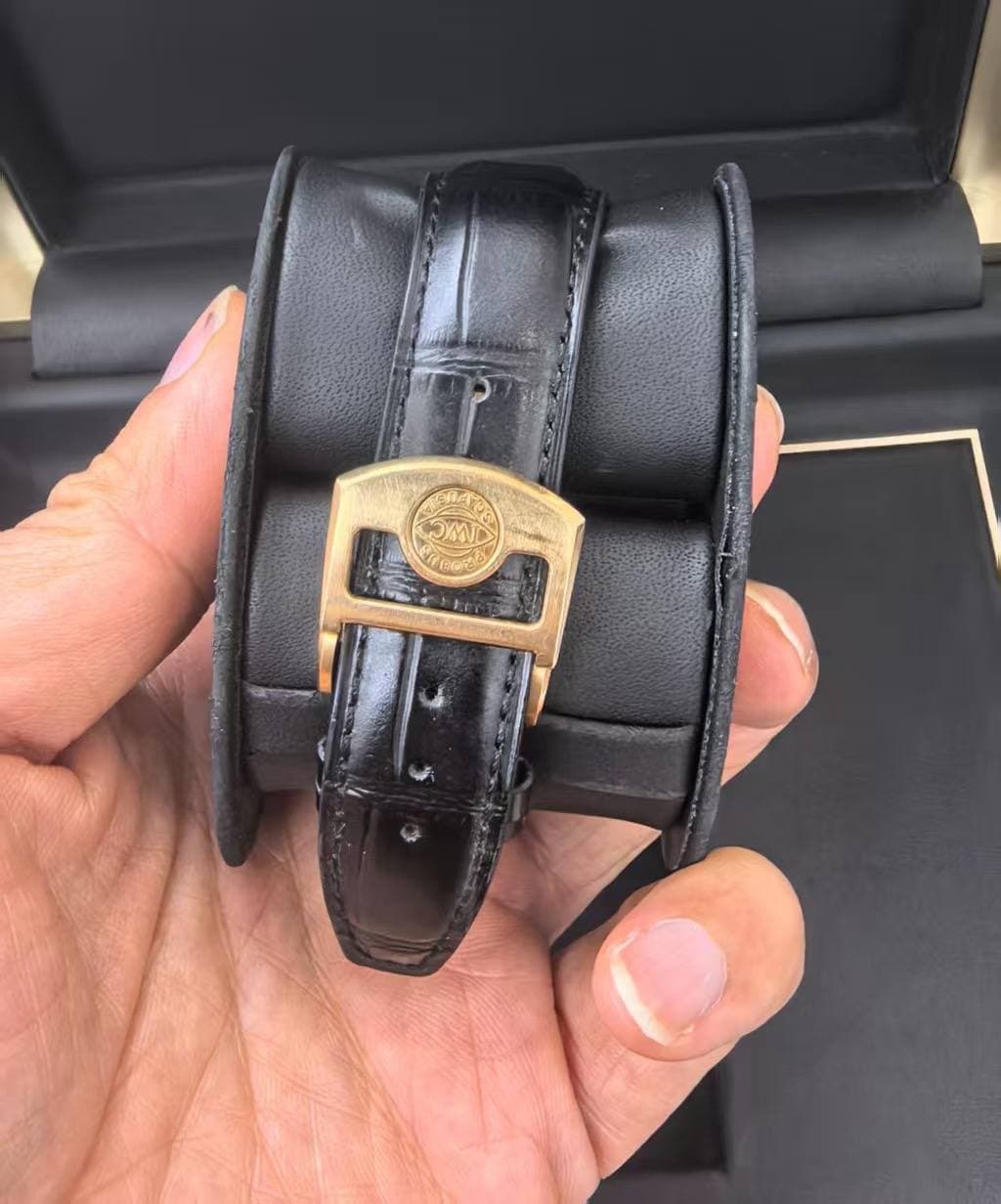 May be an image of leather, wrist watch and text