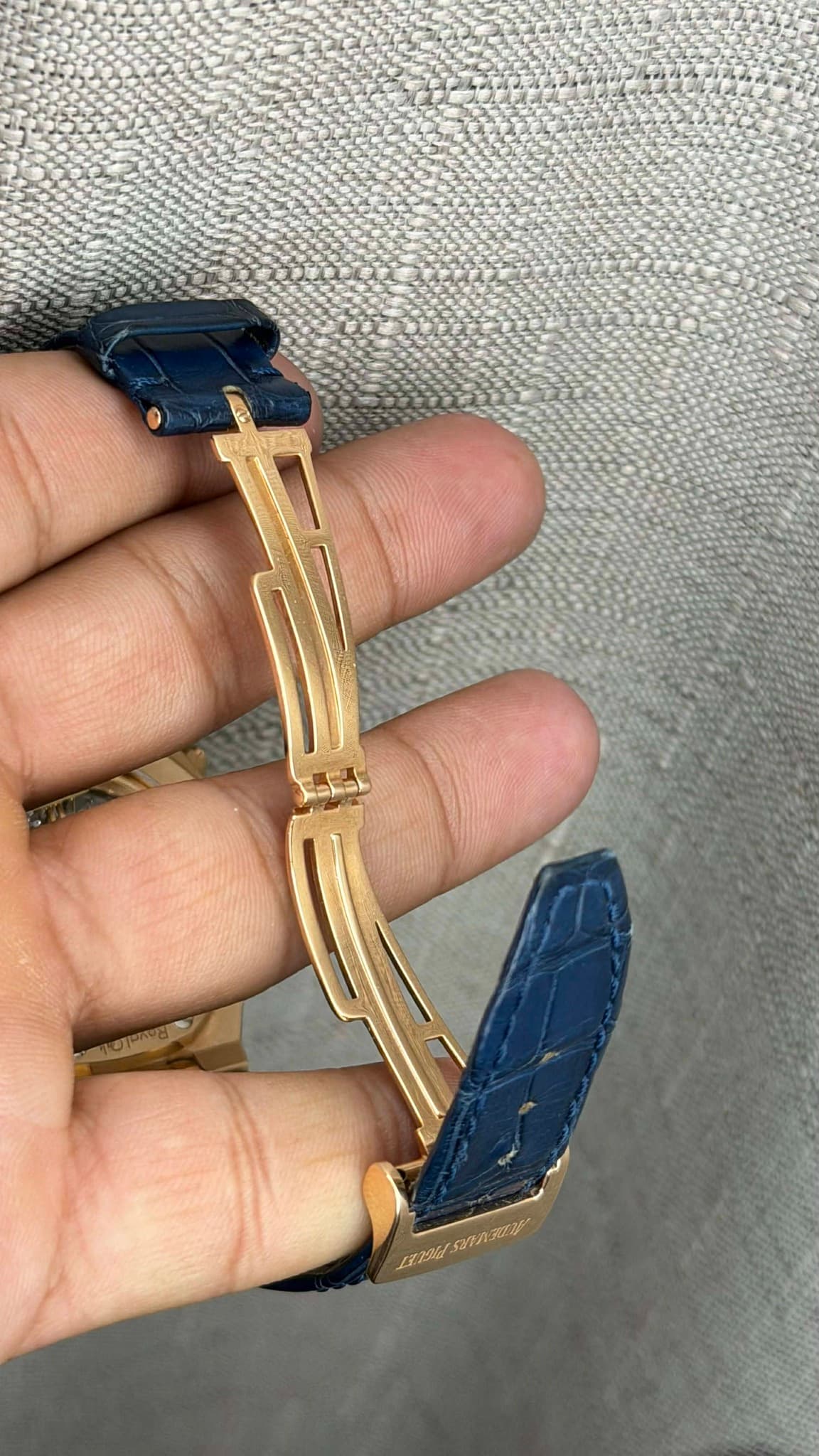 May be an image of saddle-stitched leather, wrist watch and text