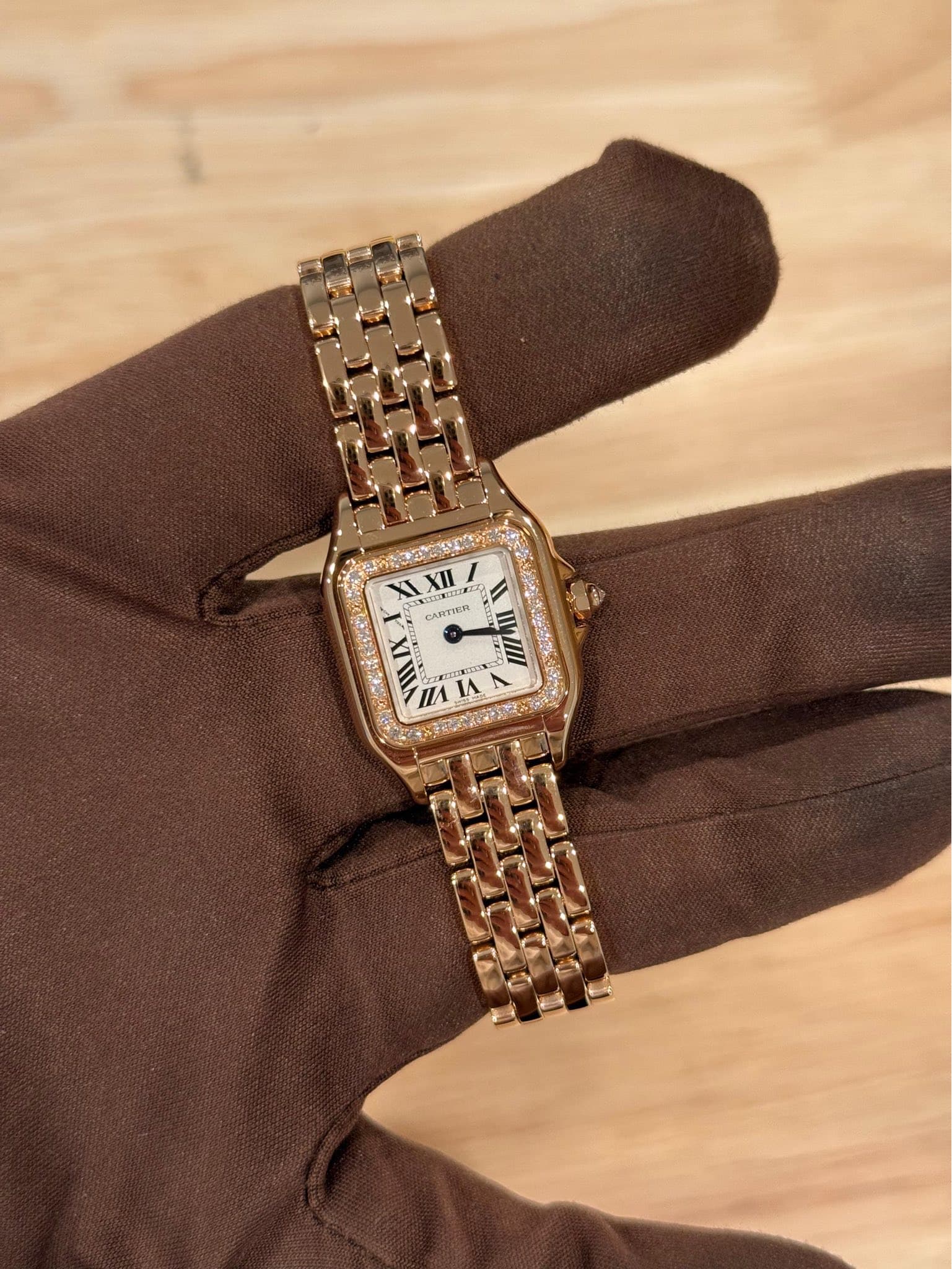 May be an image of leather, wrist watch and text
