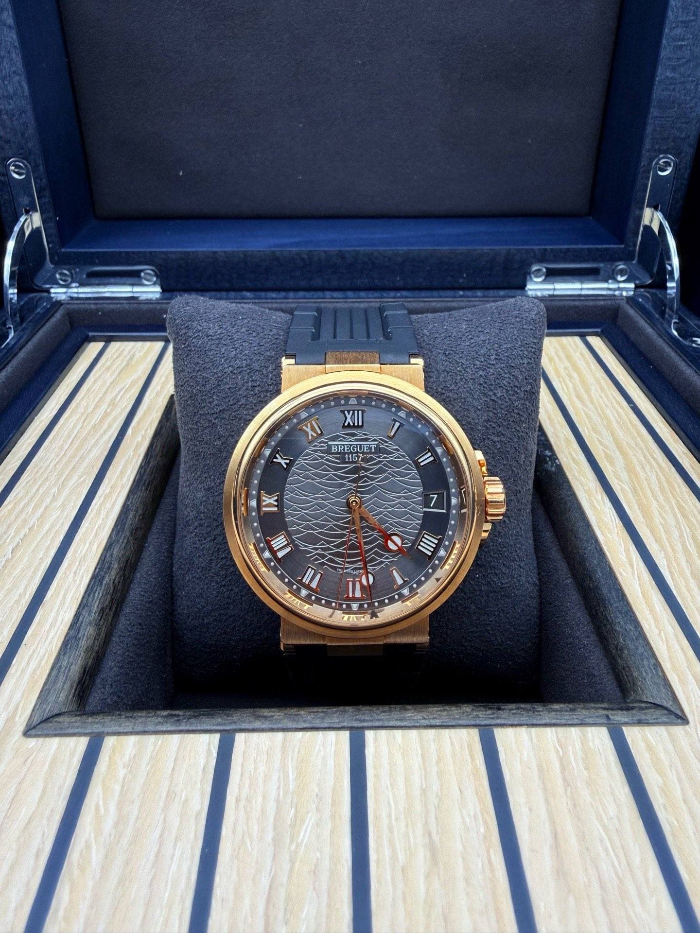 May be an image of wrist watch and text that says 'A XII XI BREGUET BHECUET BREGUET 1157 iII IX N 0 IU IIII س'
