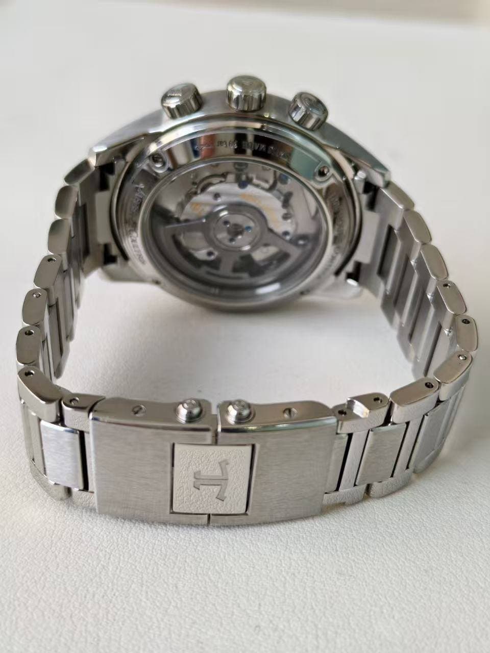 May be an image of wrist watch and text that says 'H'