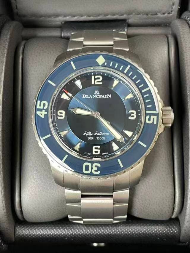 May be an image of wrist watch and text that says '12 JB BLANCPAIN CPAIN V 45 9 3 Fifty FiflyFathoms Fathoms 300m/1000ft 300m/ 1000ft መን SWISS 6 MADE NAUS 30 50'