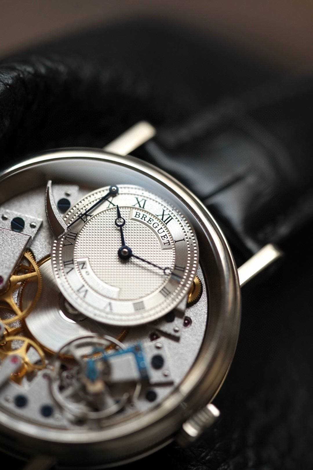 May be an image of wrist watch and text that says 'BREGUET ซ E XII XI ប N VI ባራ'