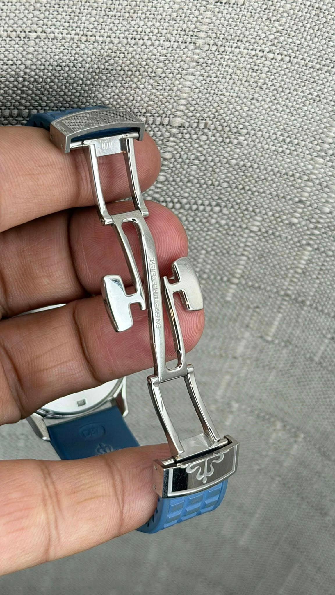 May be an image of cufflinks, wrist watch and text