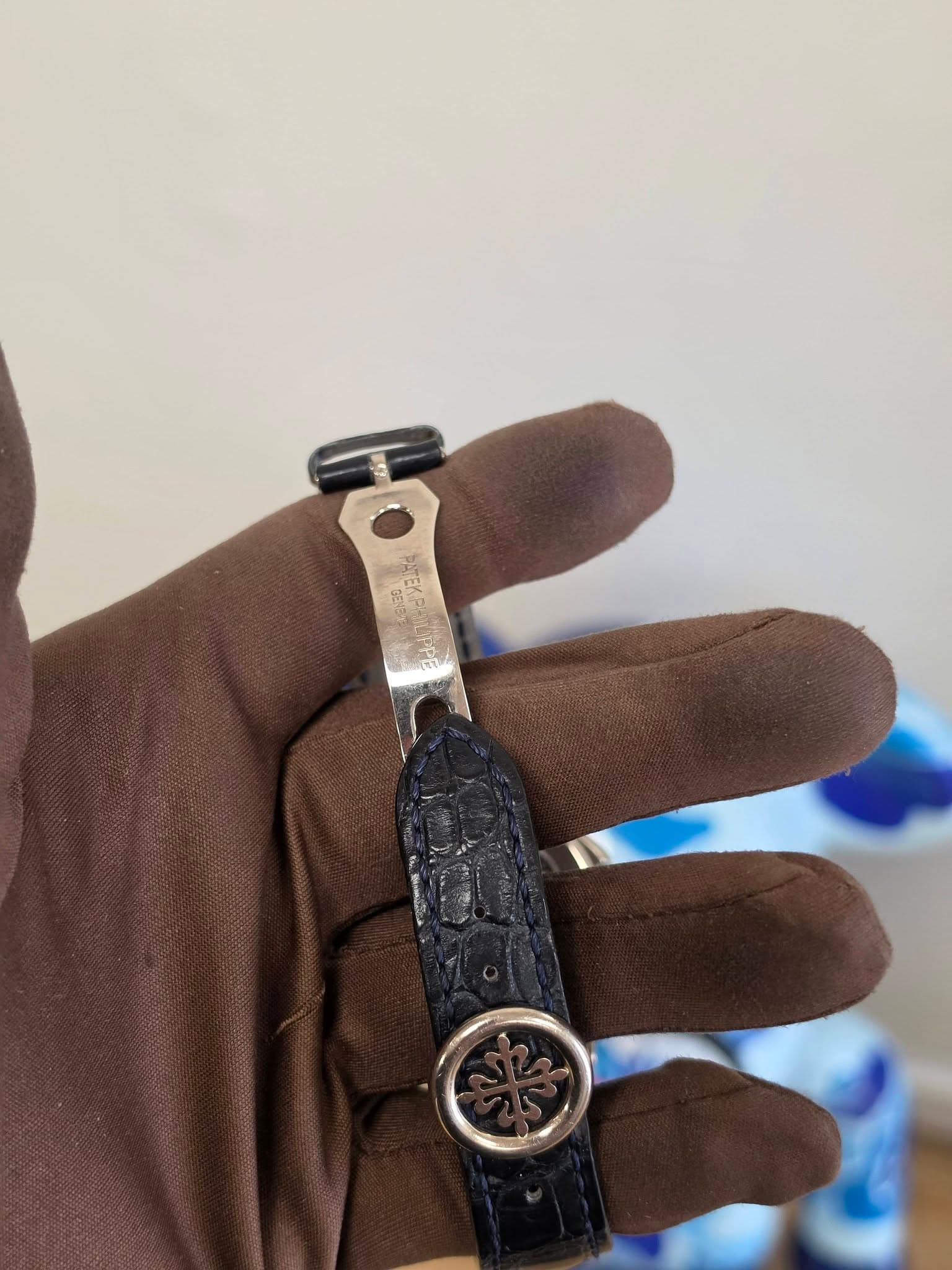 May be an image of saddle-stitched leather, wrist watch and leather