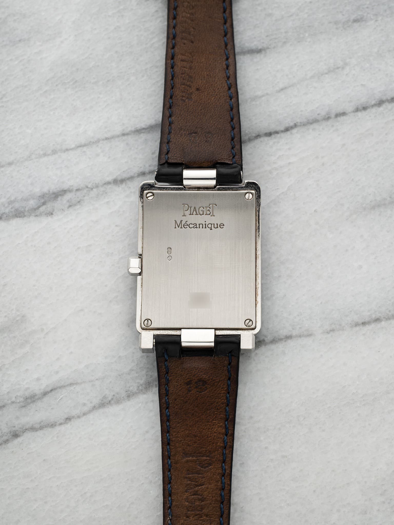 May be an image of leather, wrist watch and text that says 'PIAGET Mécanique FUCA ಿರು'