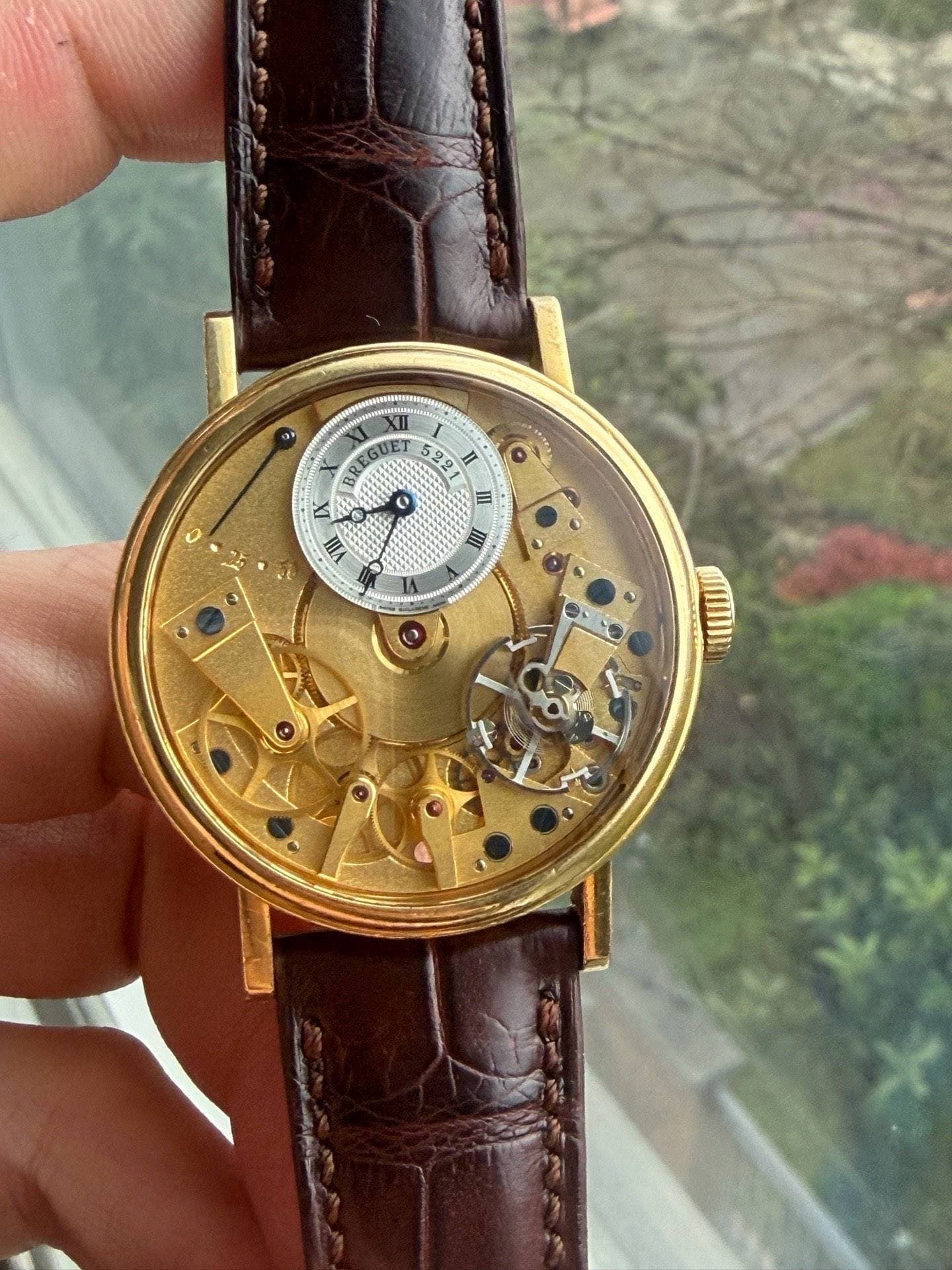 May be an image of wrist watch and text