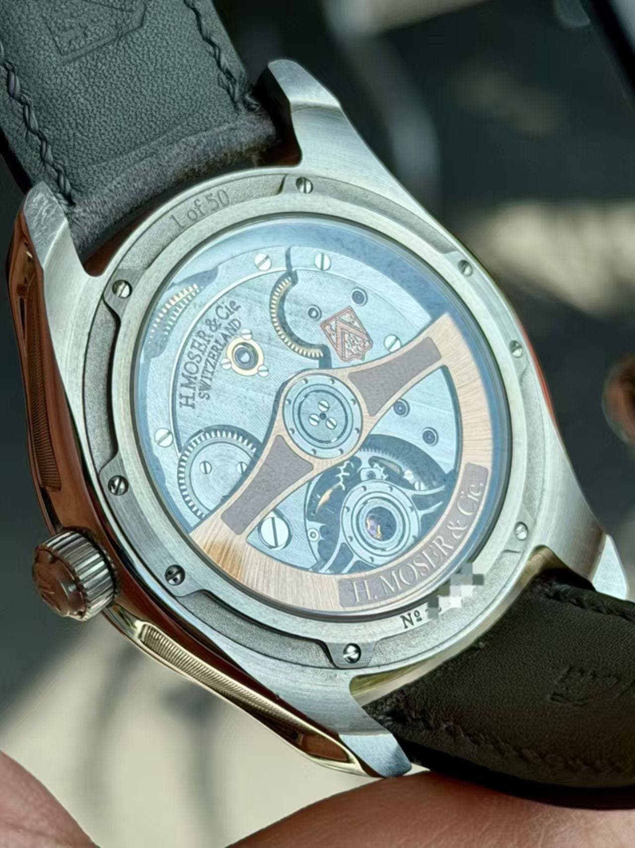 May be an image of wrist watch and text that says 'Lof50 &Cie LMOSER HMOSER&CI SVITZLAND SVITZERL MZERLAND O ٥ ٢ II Jl 小 MOSER No'