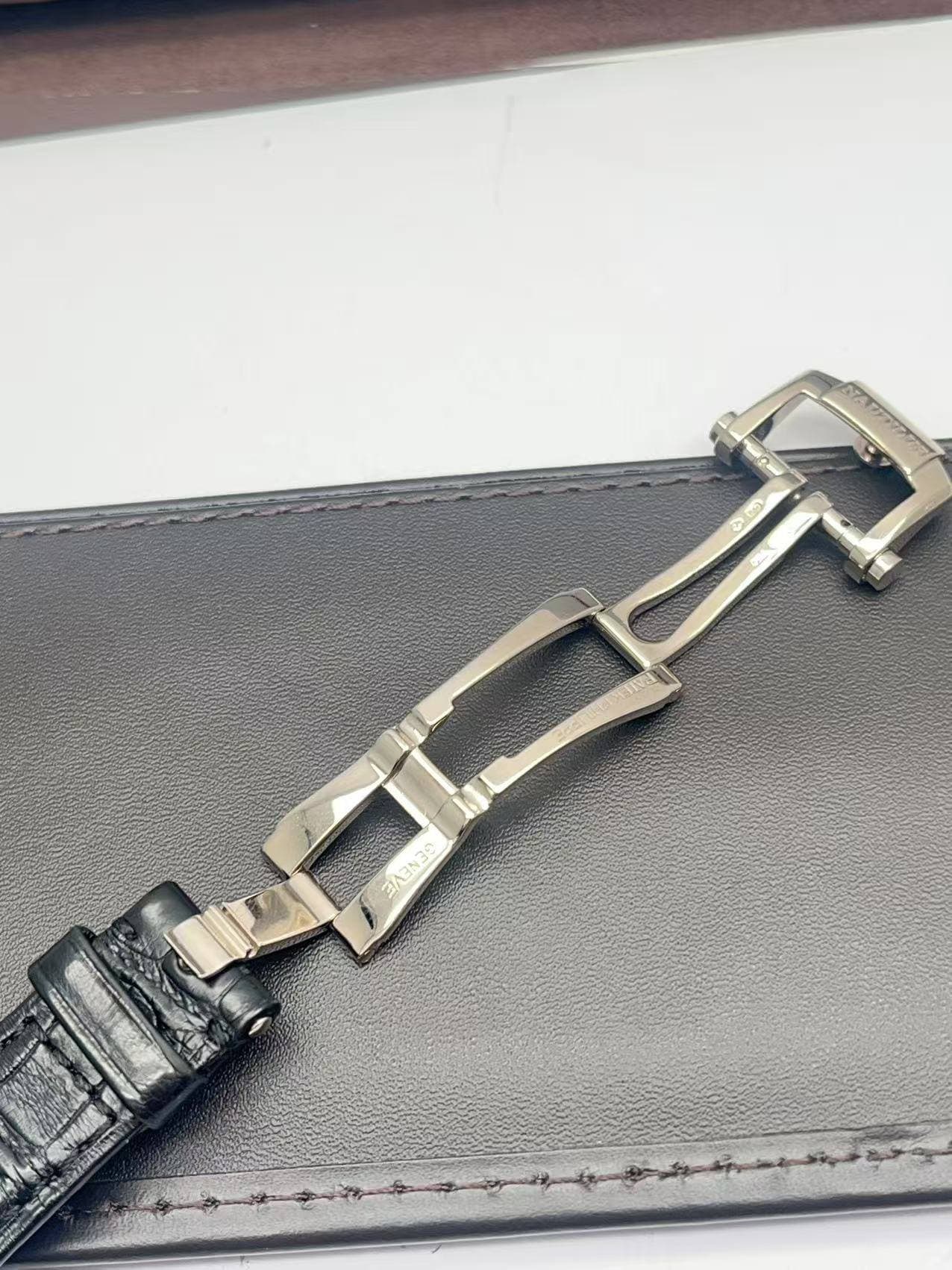 May be an image of saddle-stitched leather and wrist watch