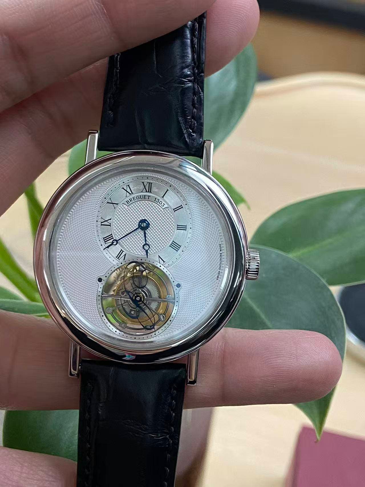 May be an image of wrist watch and text that says 'REGUE 303 303 IX हूल رل y III EI A D'