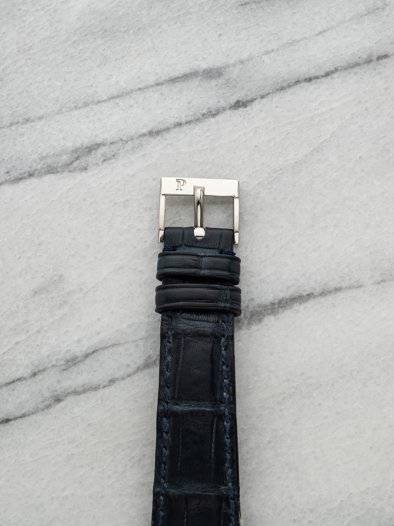 May be an image of leather, wrist watch and saddle-stitched leather