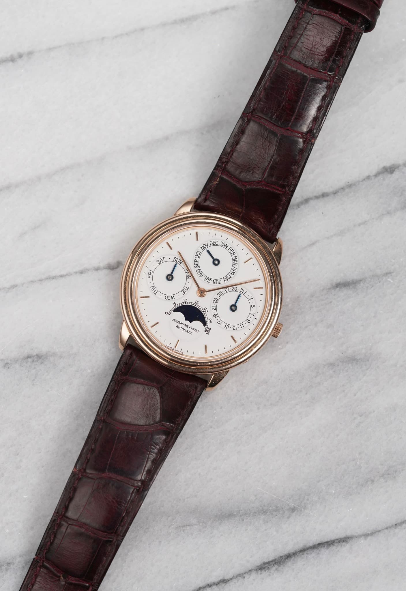 May be an image of leather, wrist watch and text