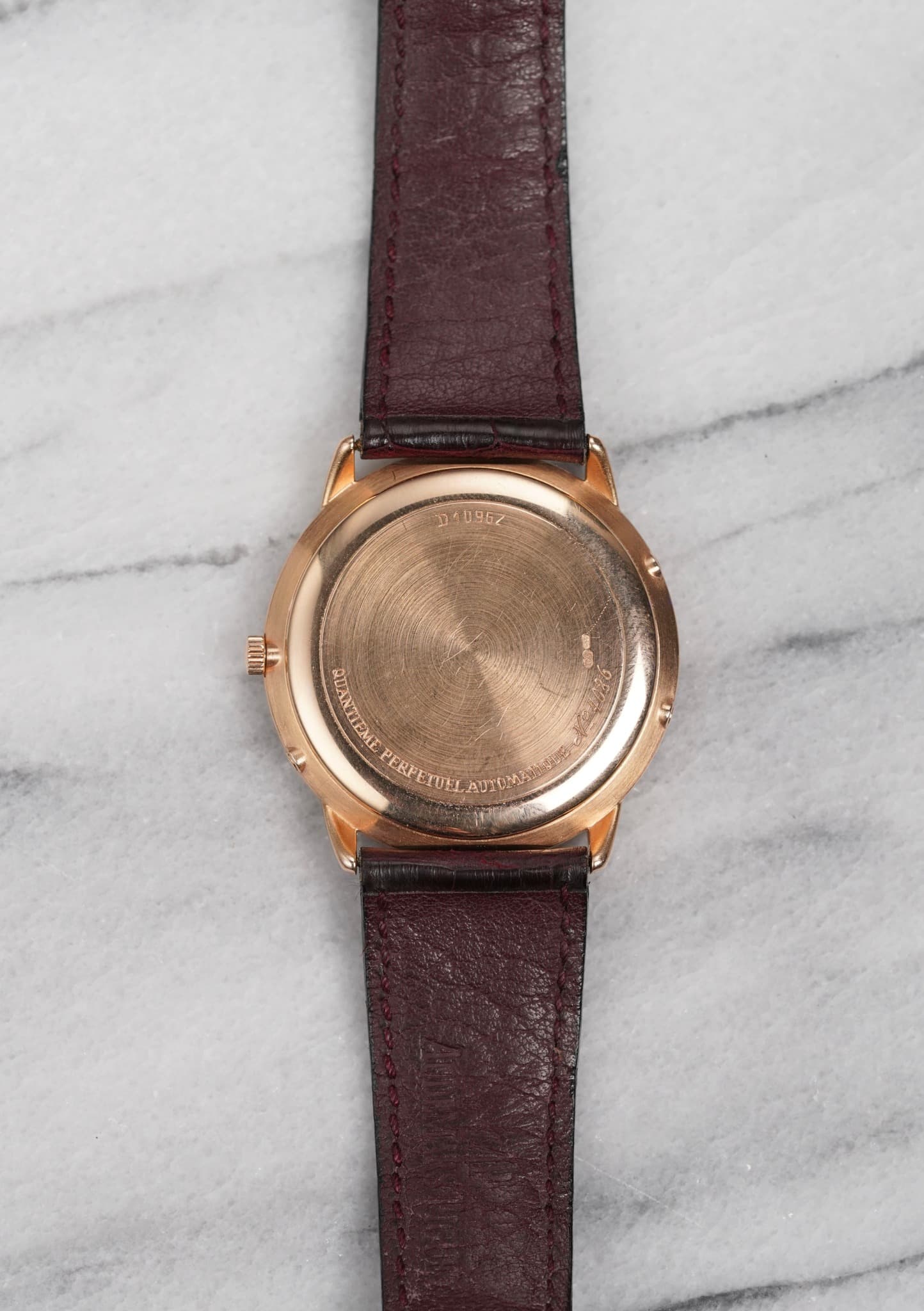May be an image of wrist watch, leather and text