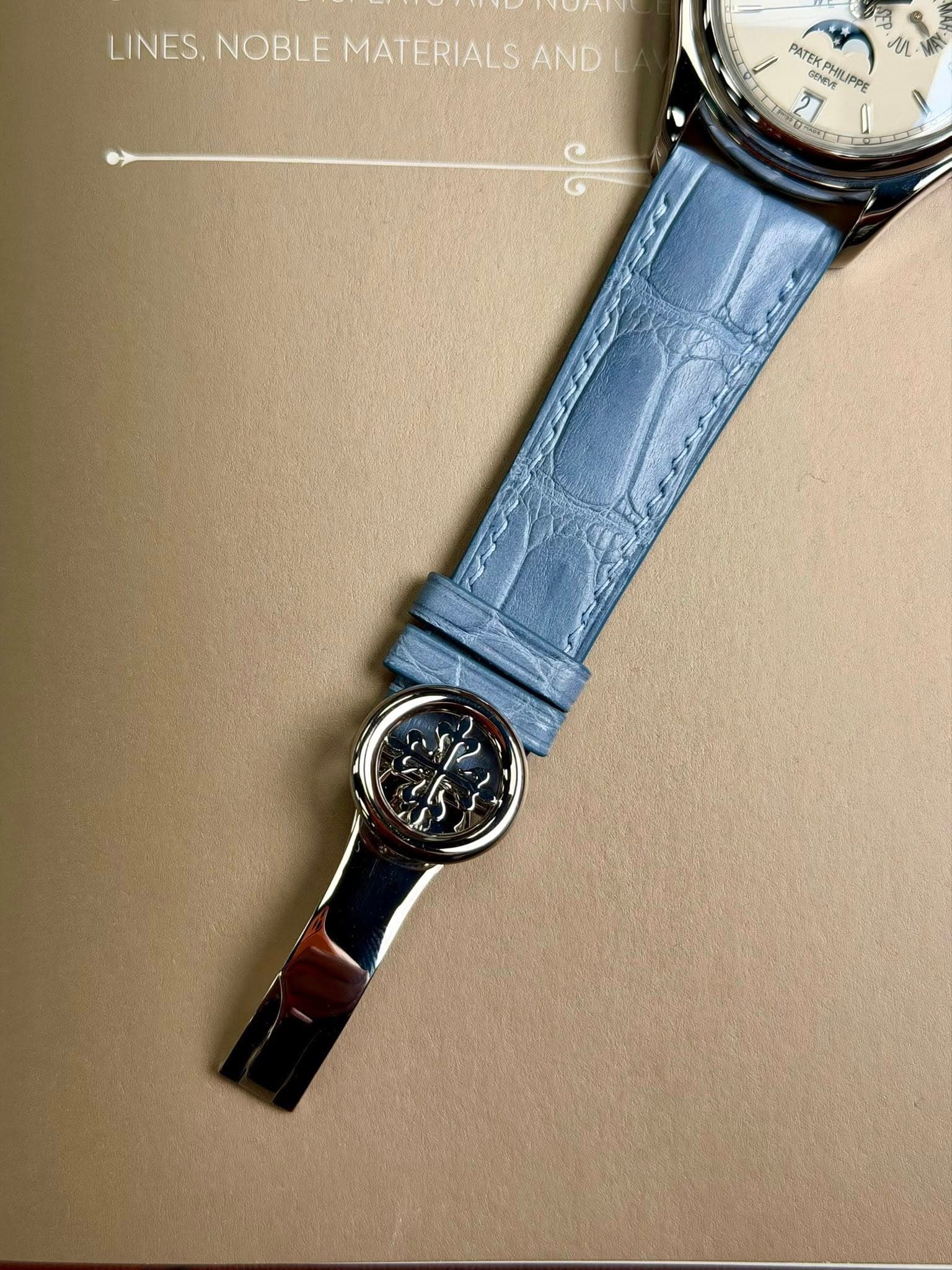 May be an image of wrist watch and text that says 'LINES.NOBLEMATERIALSAND LINES, NOBLE MATERIALS AND PATEK An さん GENEVE PHILIF JPPE ලල'