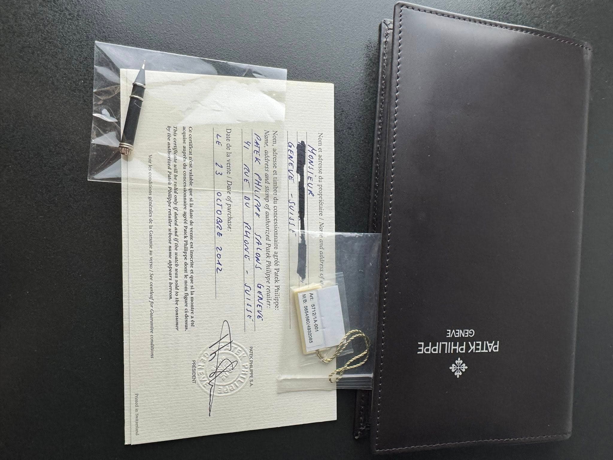 May be an image of leather wallet, saddle-stitched leather, leather and text
