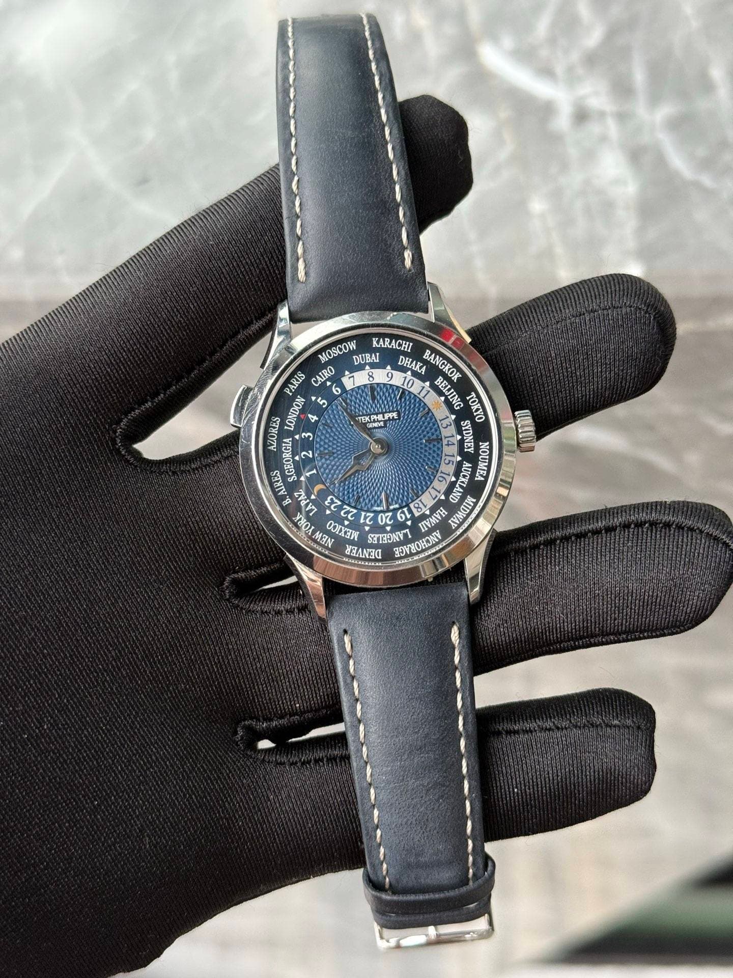 May be an image of leather, wrist watch and text