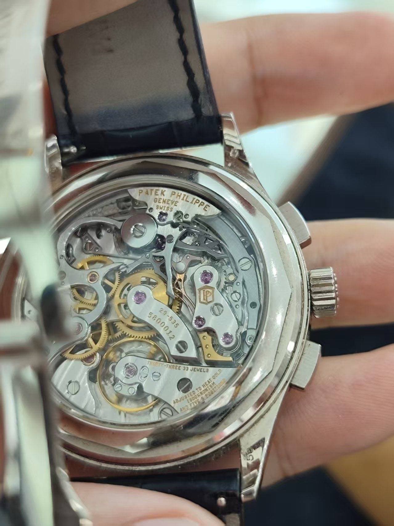 May be an image of wrist watch and text that says 'PATEK SWISS SWISS HILIPPE OENEVE TeиAbK Pr ® THREE 33 JEWELO gOi ABJUST pA RONISK HE'
