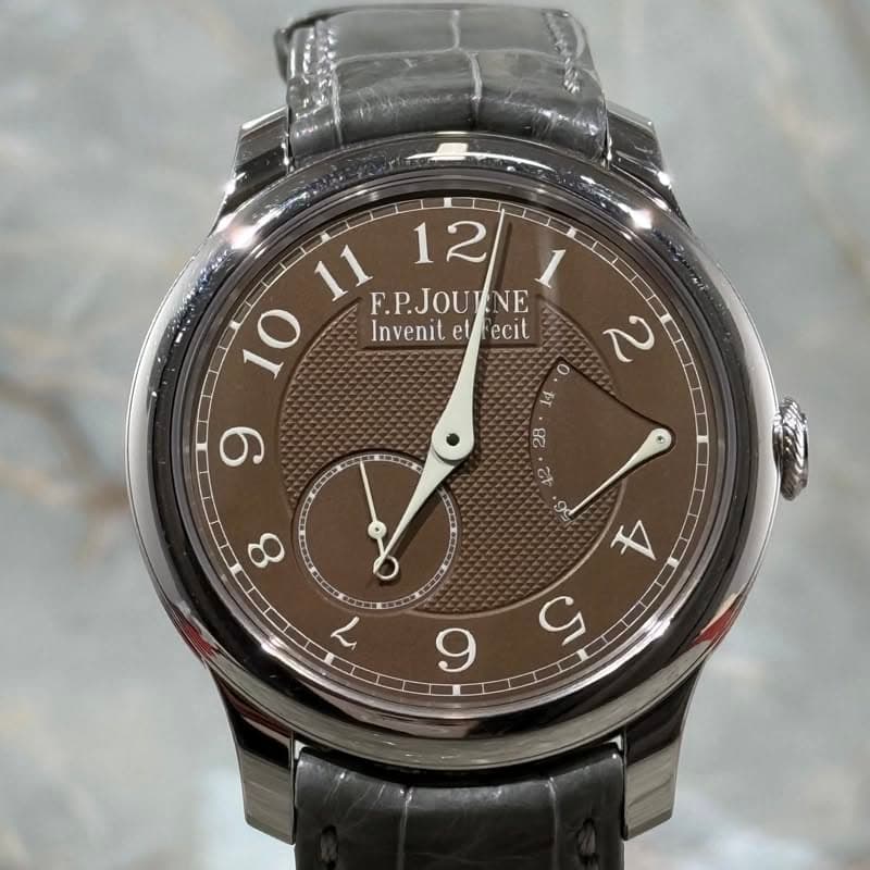 May be an image of wrist watch and text that says '11 F.P.JOULNE NE 12 1 10 Invenit InvenitetFecit et effecit ecit 2 9 ٥ 14 BC क 8 7 A S 9'