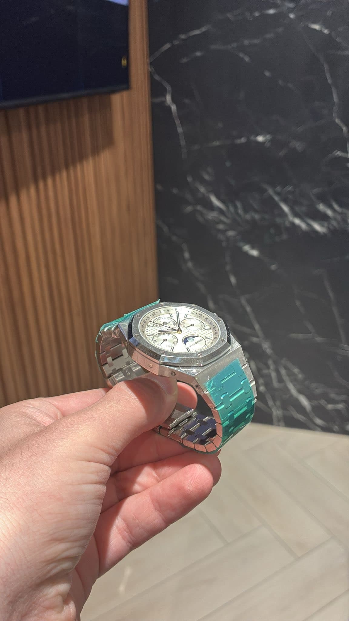 May be an image of wrist watch and text that says 'T'
