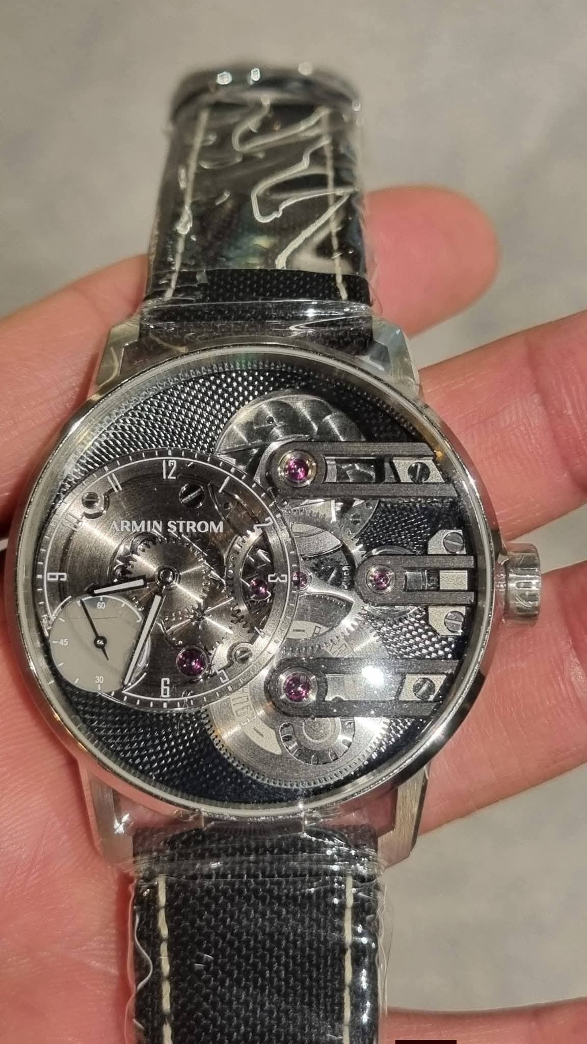 May be an image of wrist watch and text