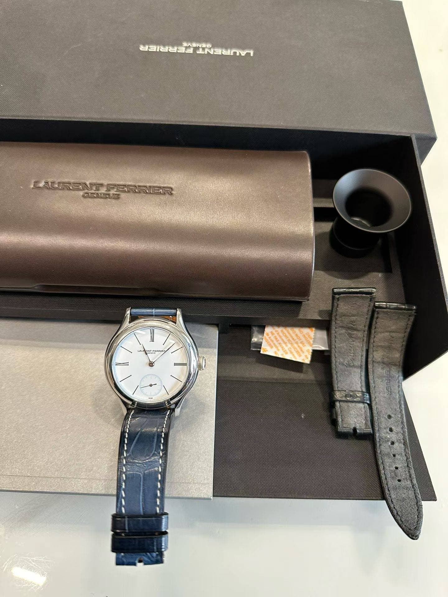 May be an image of wrist watch, saddle-stitched leather, leather and text
