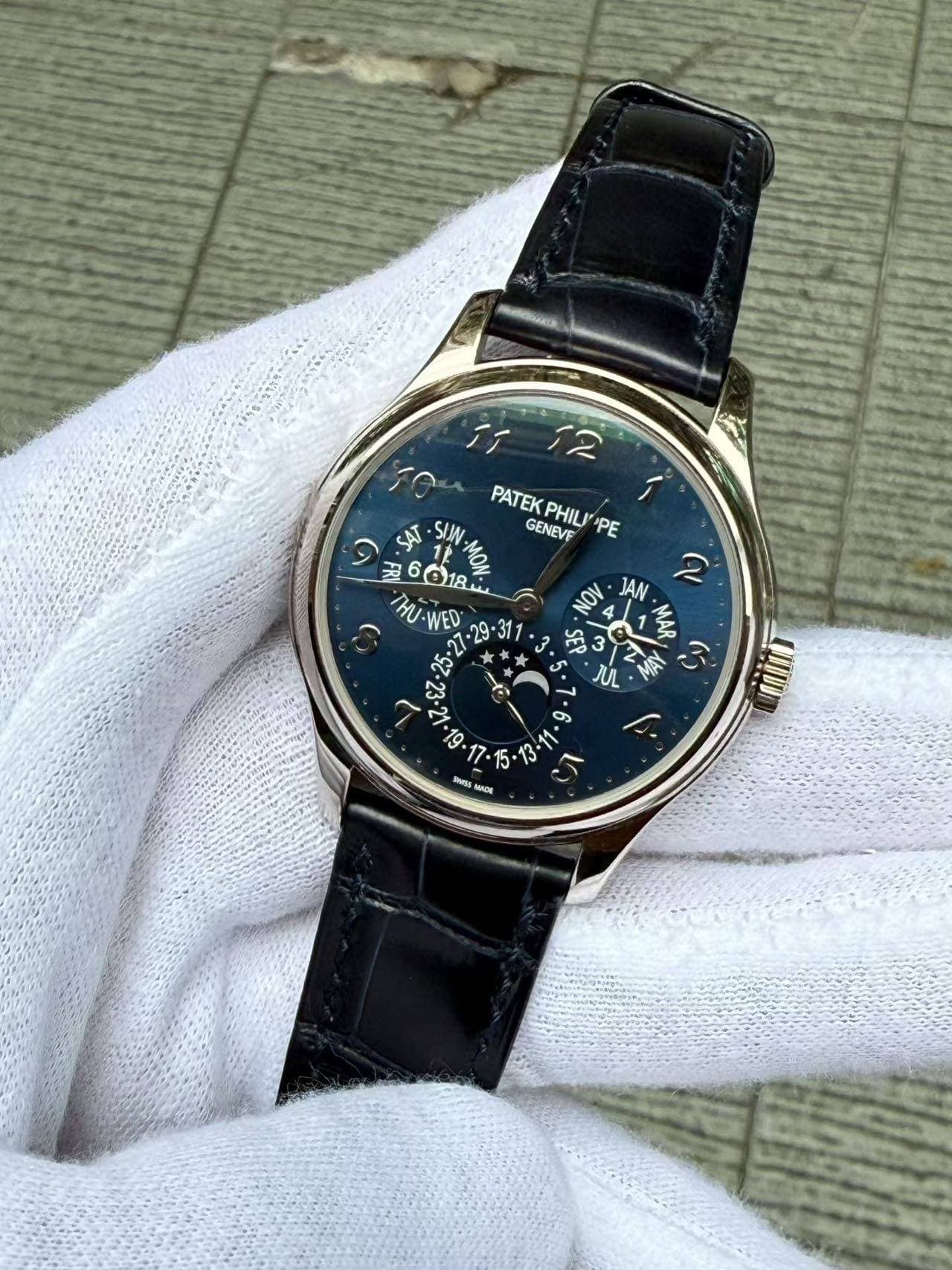 May be an image of wrist watch and text that says 'MAOAO اَاَ 12 PATEKPHIL"PE 1 PATEK GENEVF PHIL PE MU-WED JAN q MAR JUL 6s න 13-11 ا 11 Is. UIIIU Semss แบวรี'