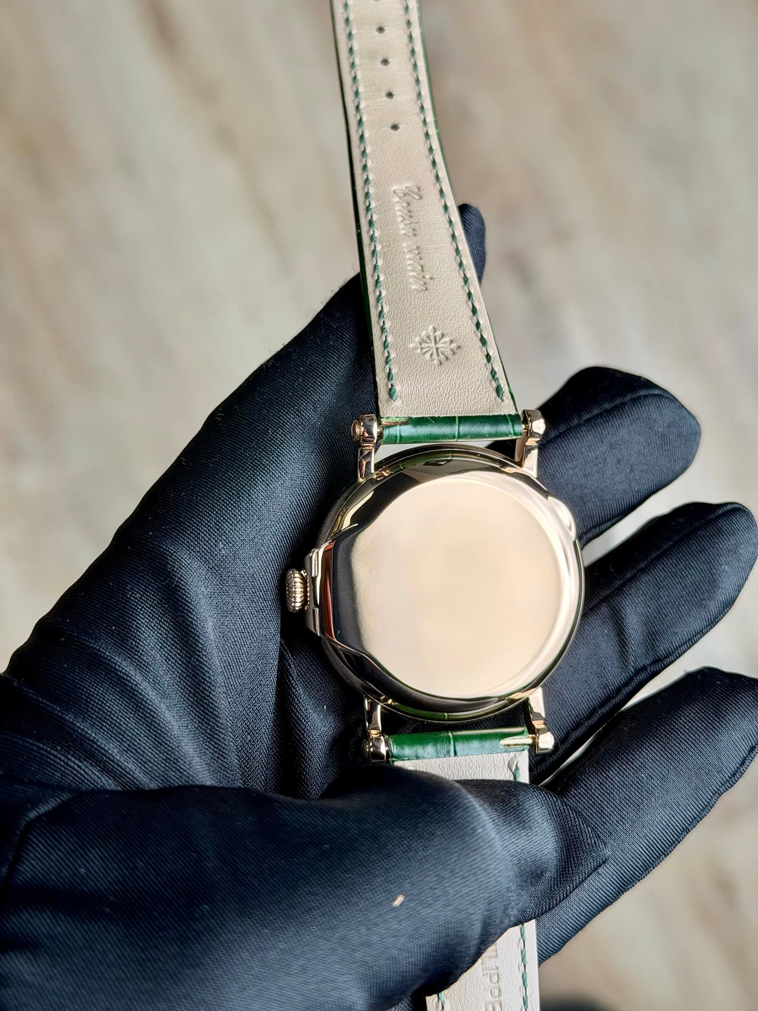 May be an image of leather, wrist watch and text