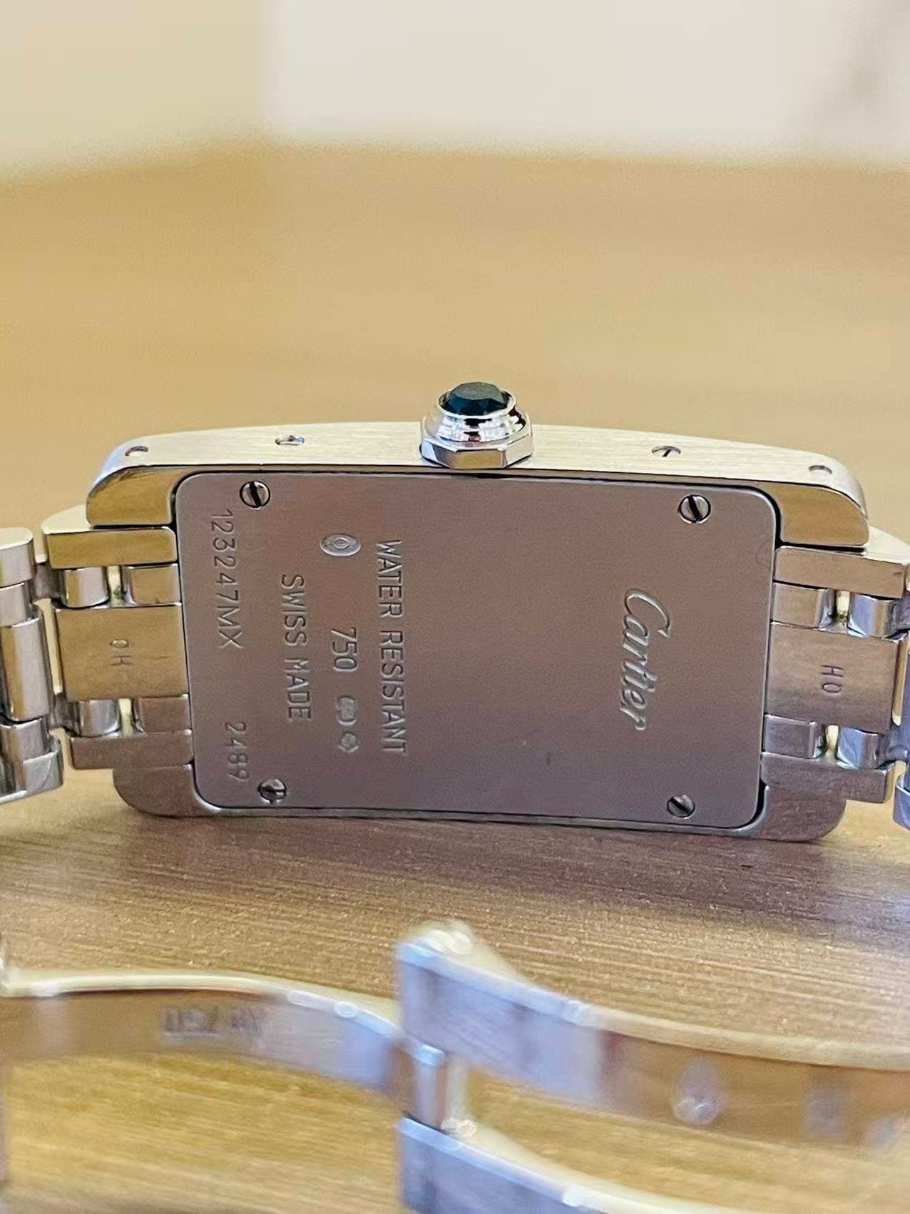 May be an image of digital watch and text that says '1232 123247MX O SWISS 750 WATER.RESISTANT RESISTANT WATER MADE SWISSMADE 9 መግ 5009 e> HO Cartler t Cartier 時天 na2y'