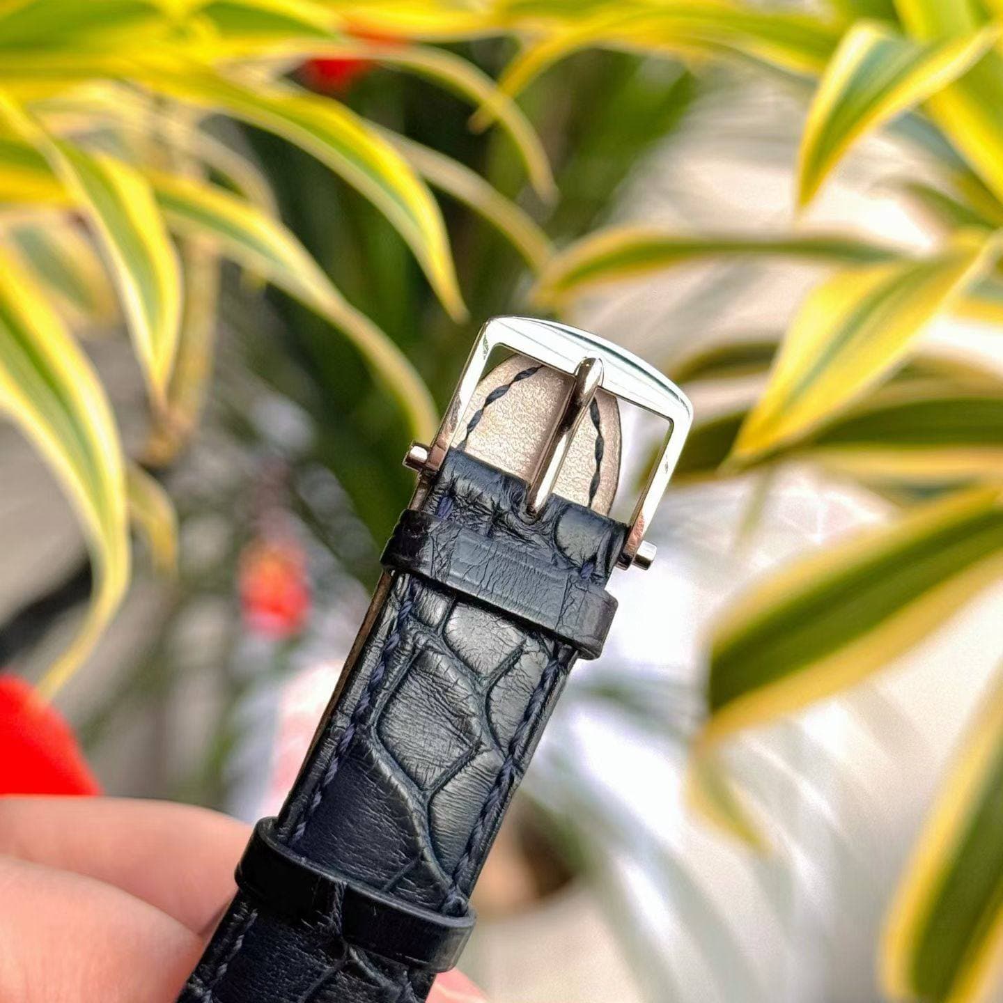May be an image of saddle-stitched leather and wrist watch