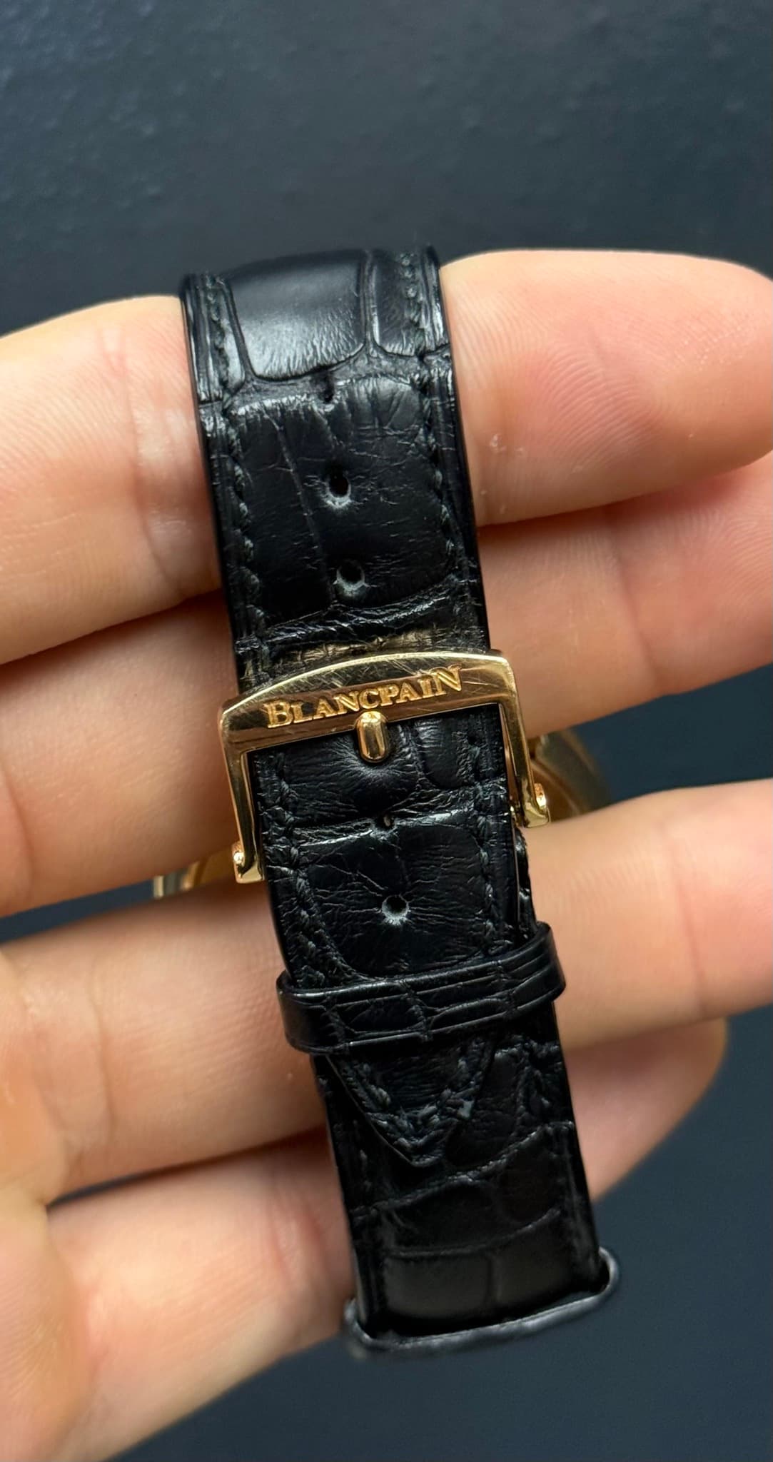 May be an image of leather, wrist watch and text