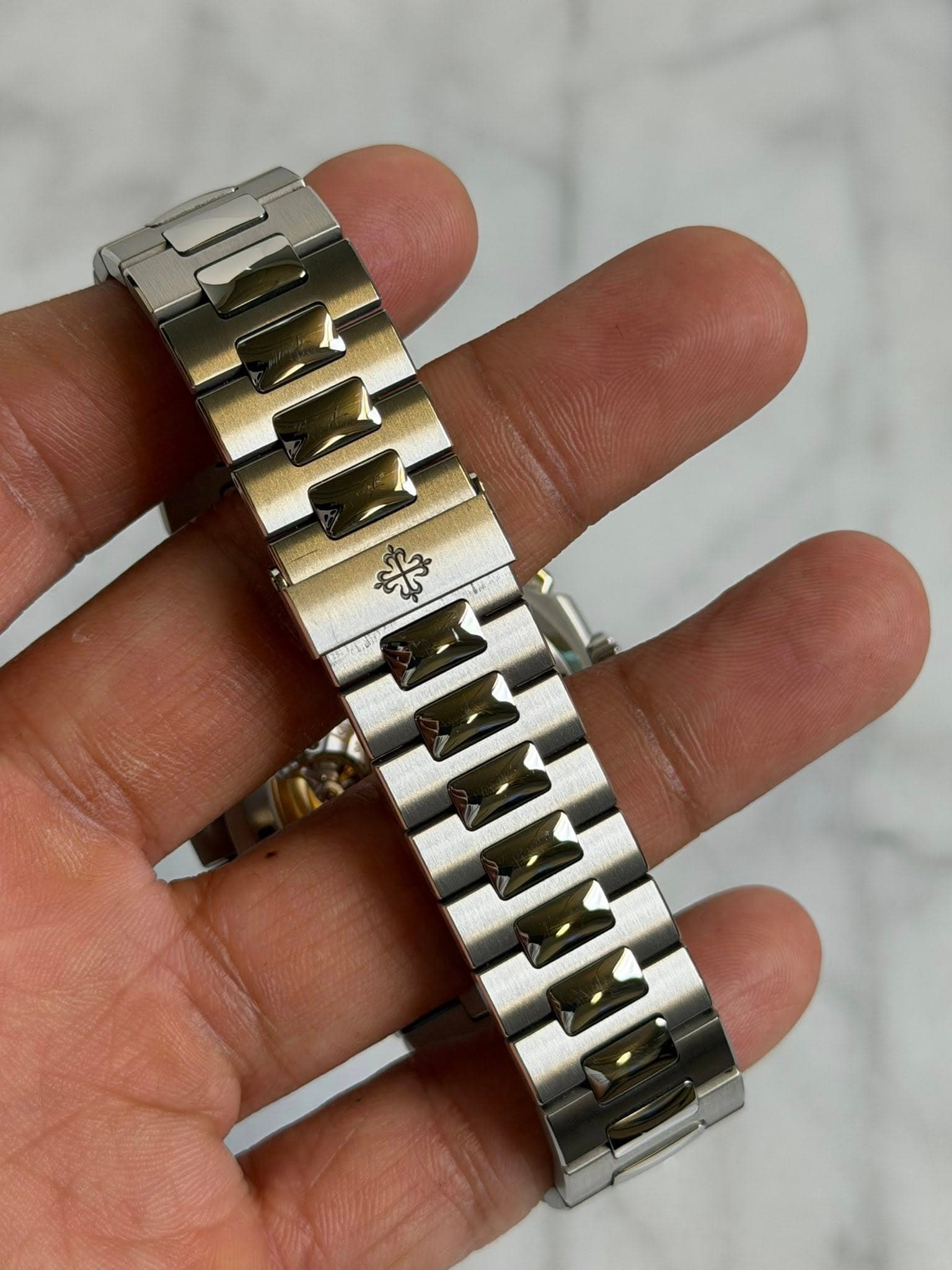 May be an image of digital watch, jewelry and text