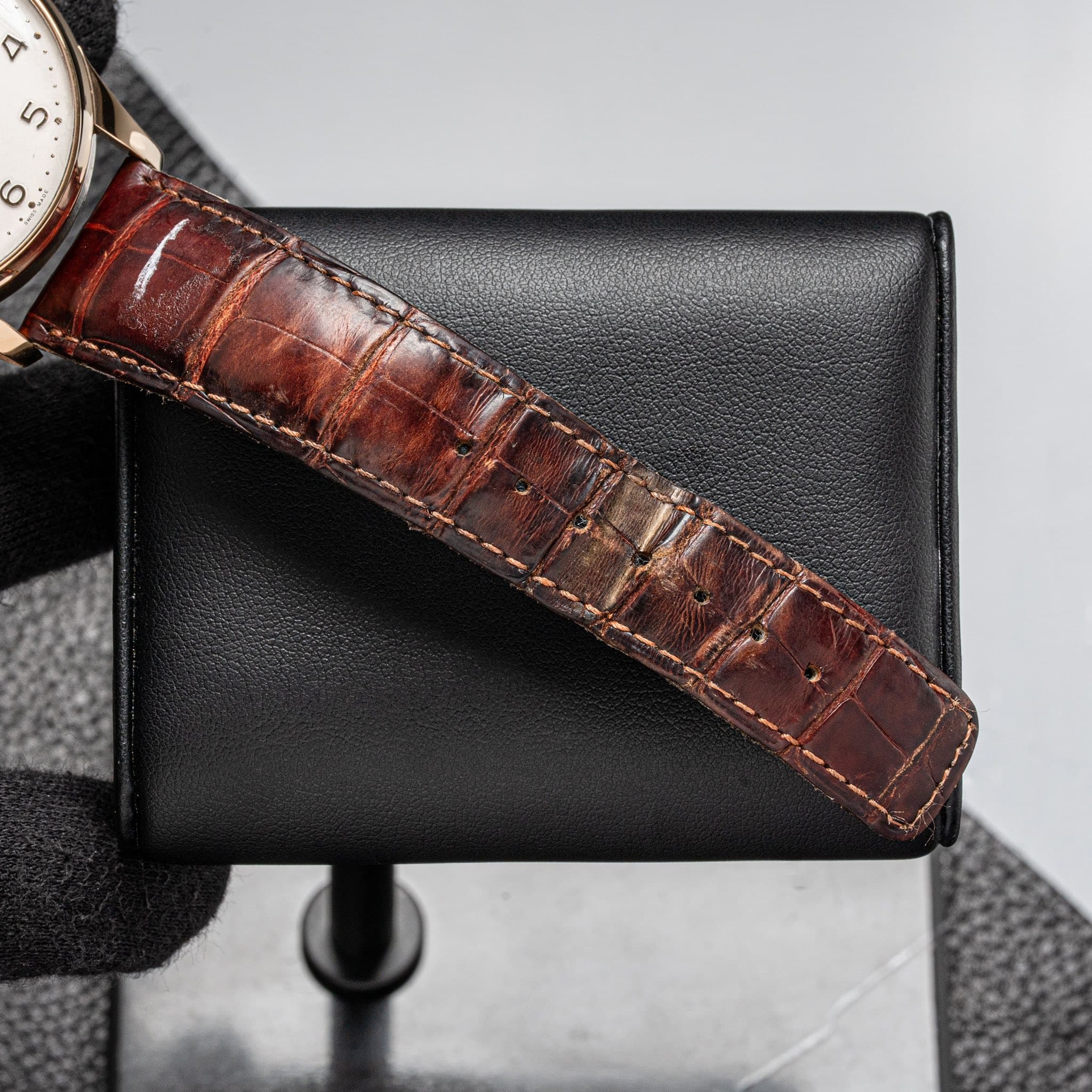 May be an image of leather, wrist watch and saddle-stitched leather