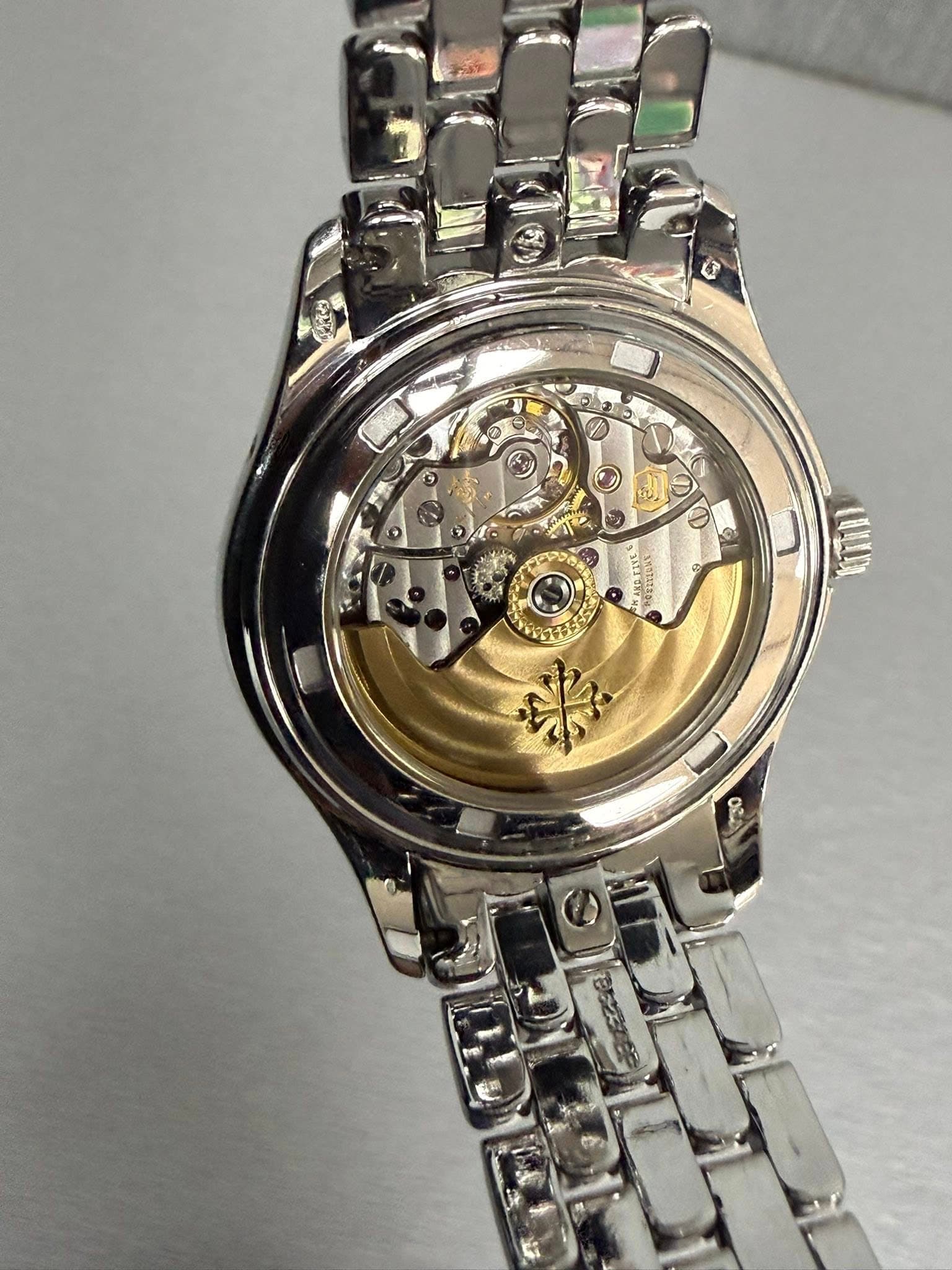 May be an image of wrist watch and text