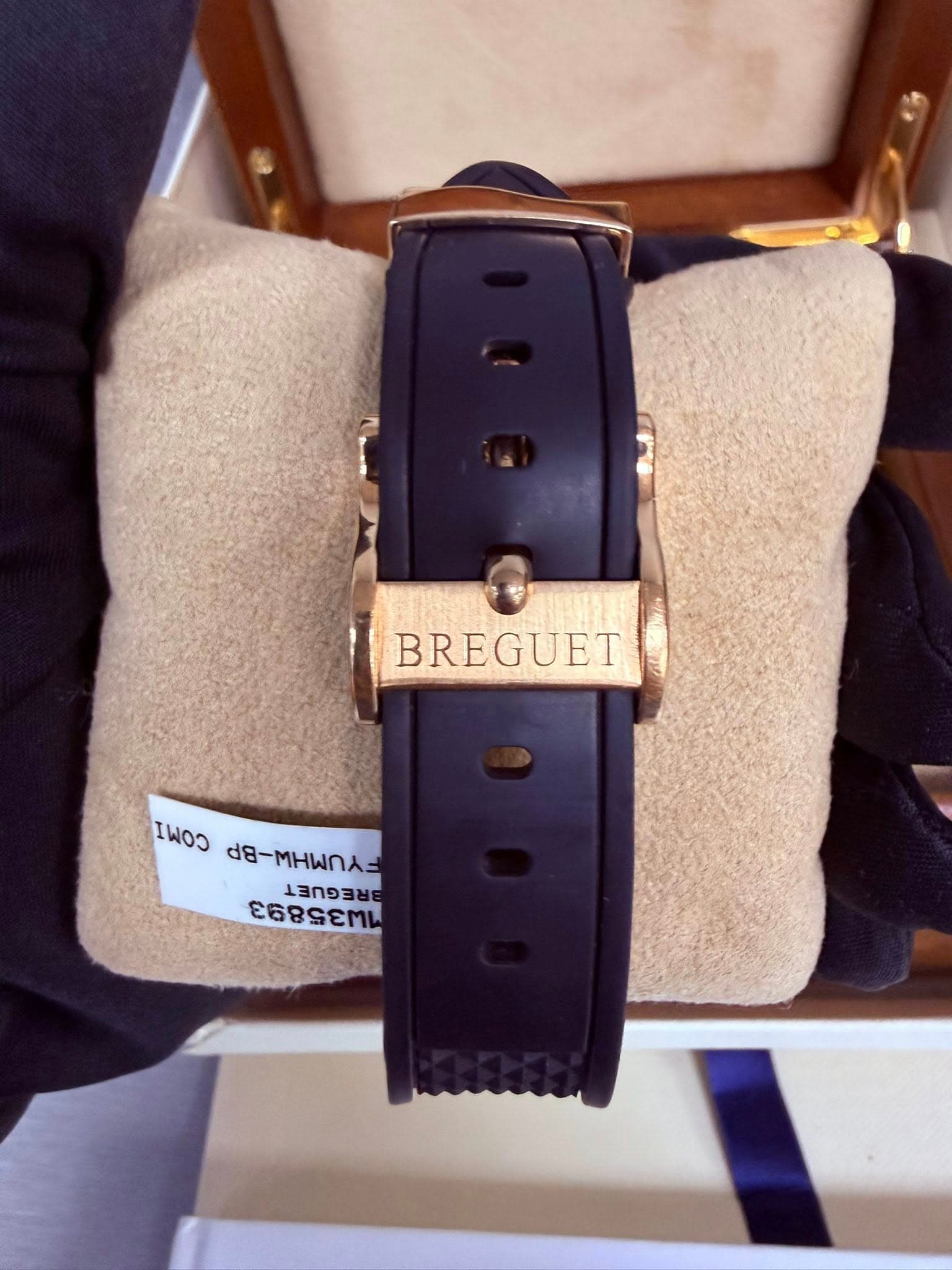 May be an image of wrist watch, leather and text