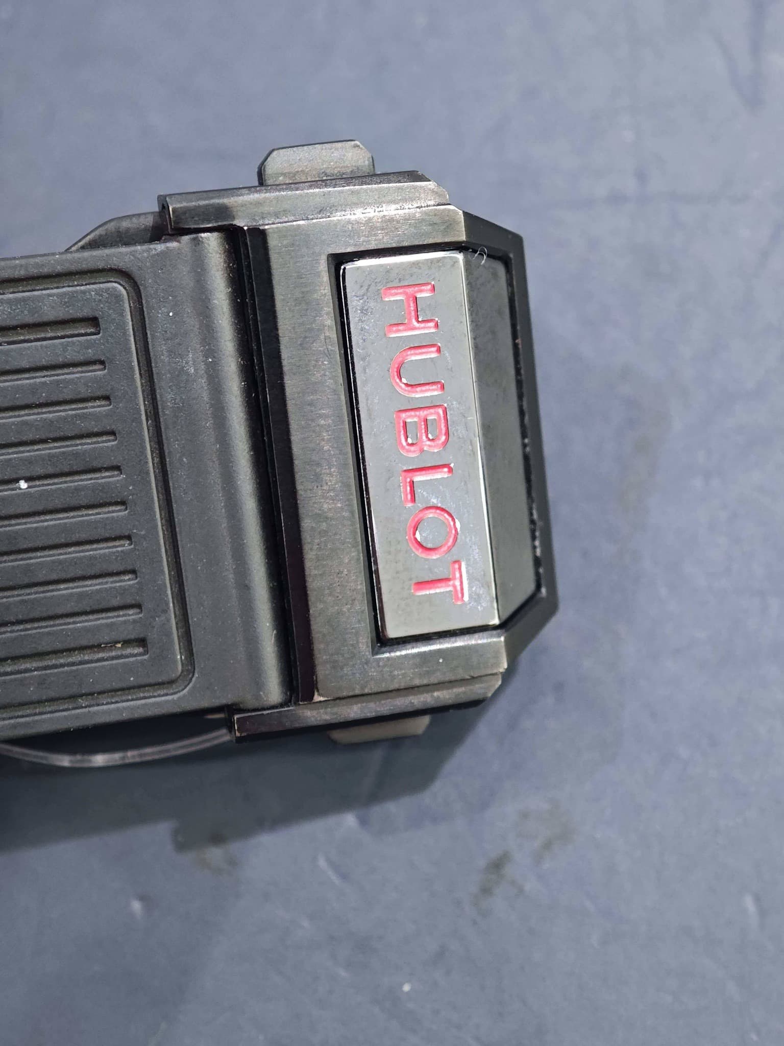 May be an image of lighter, digital watch and text that says 'UBLOT HUBLOT'