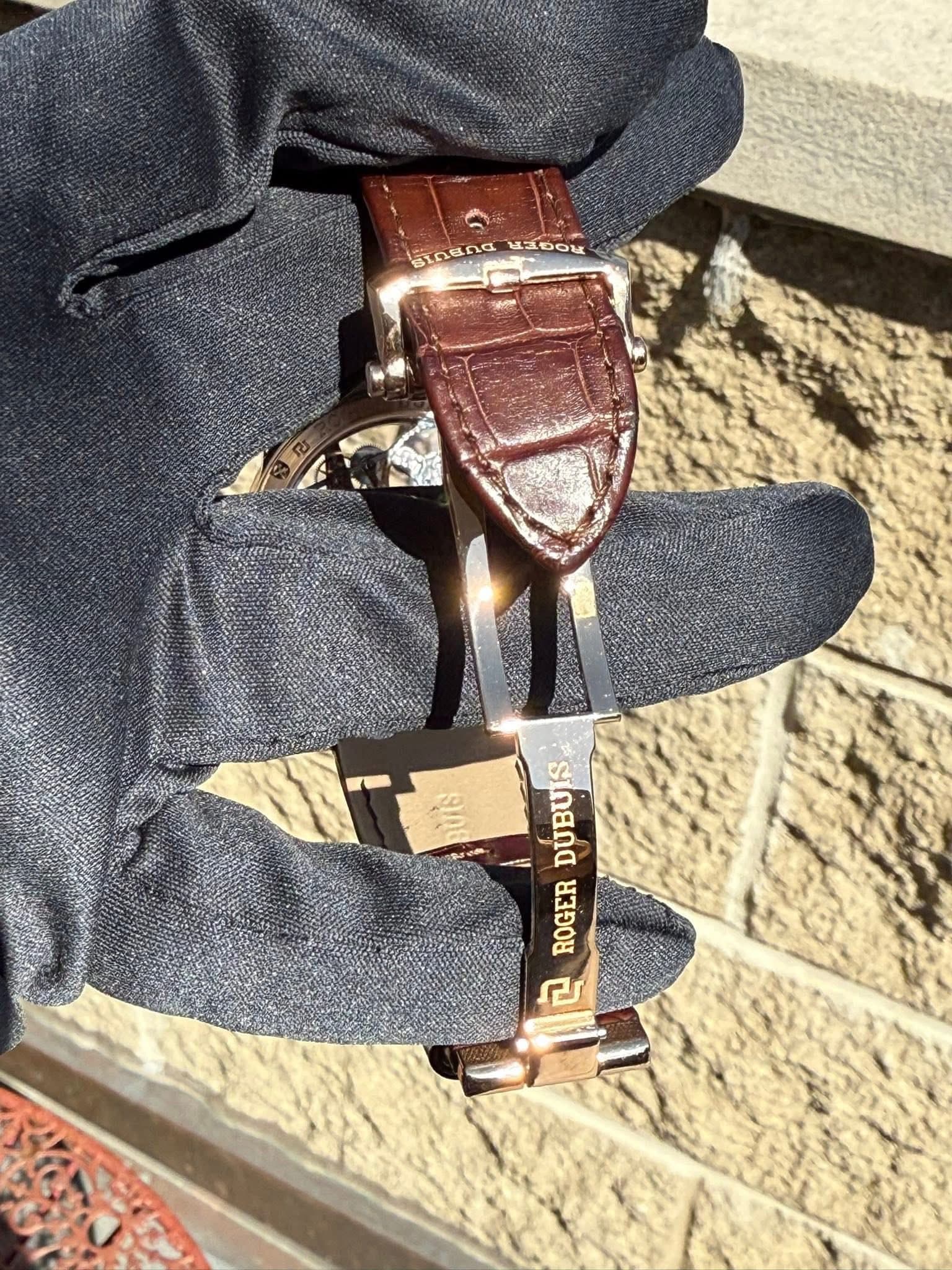 May be an image of leather, wrist watch and saddle-stitched leather