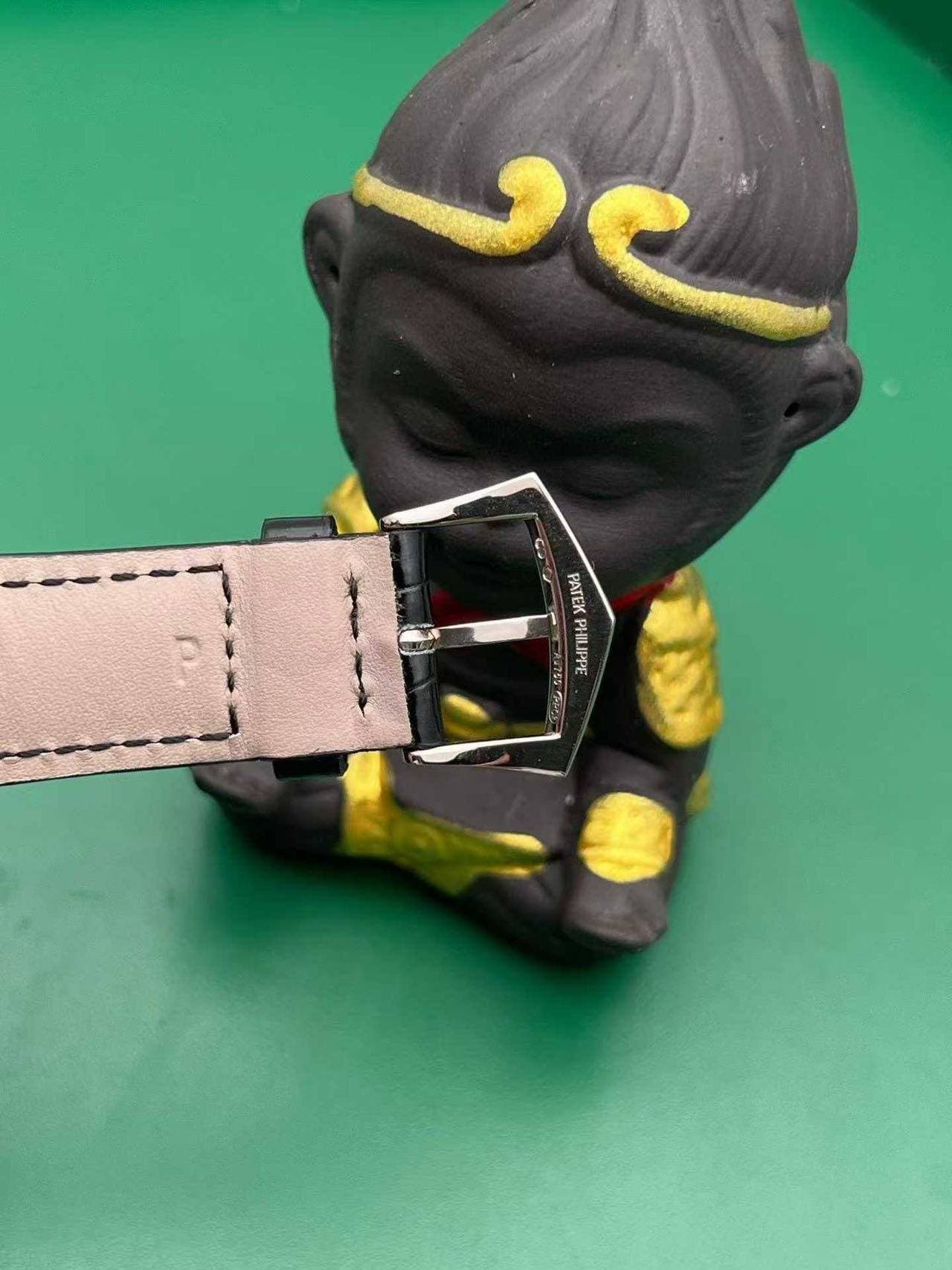 May be an image of saddle-stitched leather, wrist watch and leather