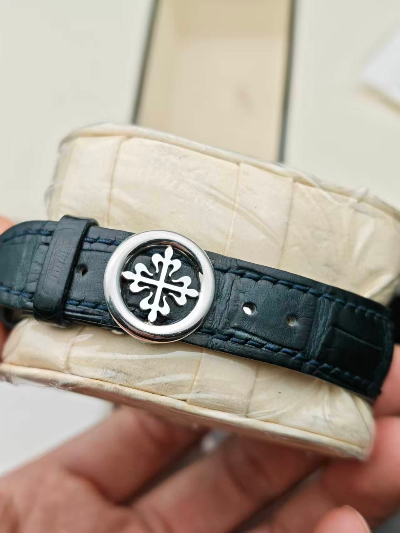May be an image of leather, wrist watch and text