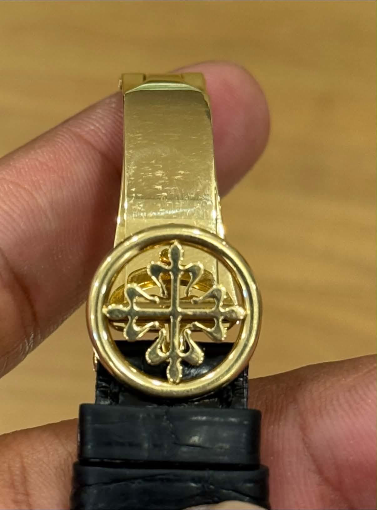 May be an image of wrist watch and text