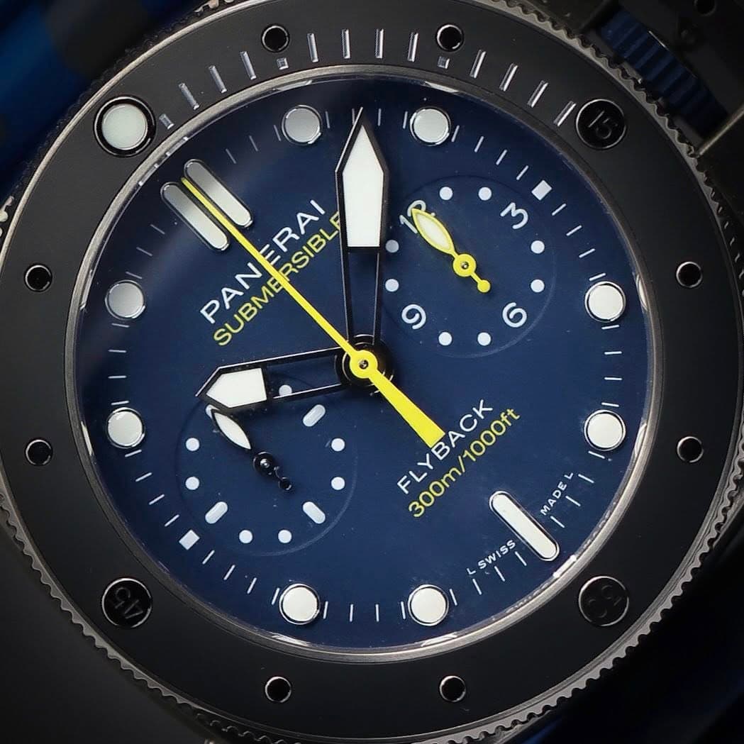 May be an image of wrist watch and text that says 'OR PANERAI P SUBMERSIBLF ERAI RSIBLE PAN SUBME FLYBACK 300m/1 300m/1000ft 300m/100 1000ft DE MA MADE I MA SWISS Ss SWI'