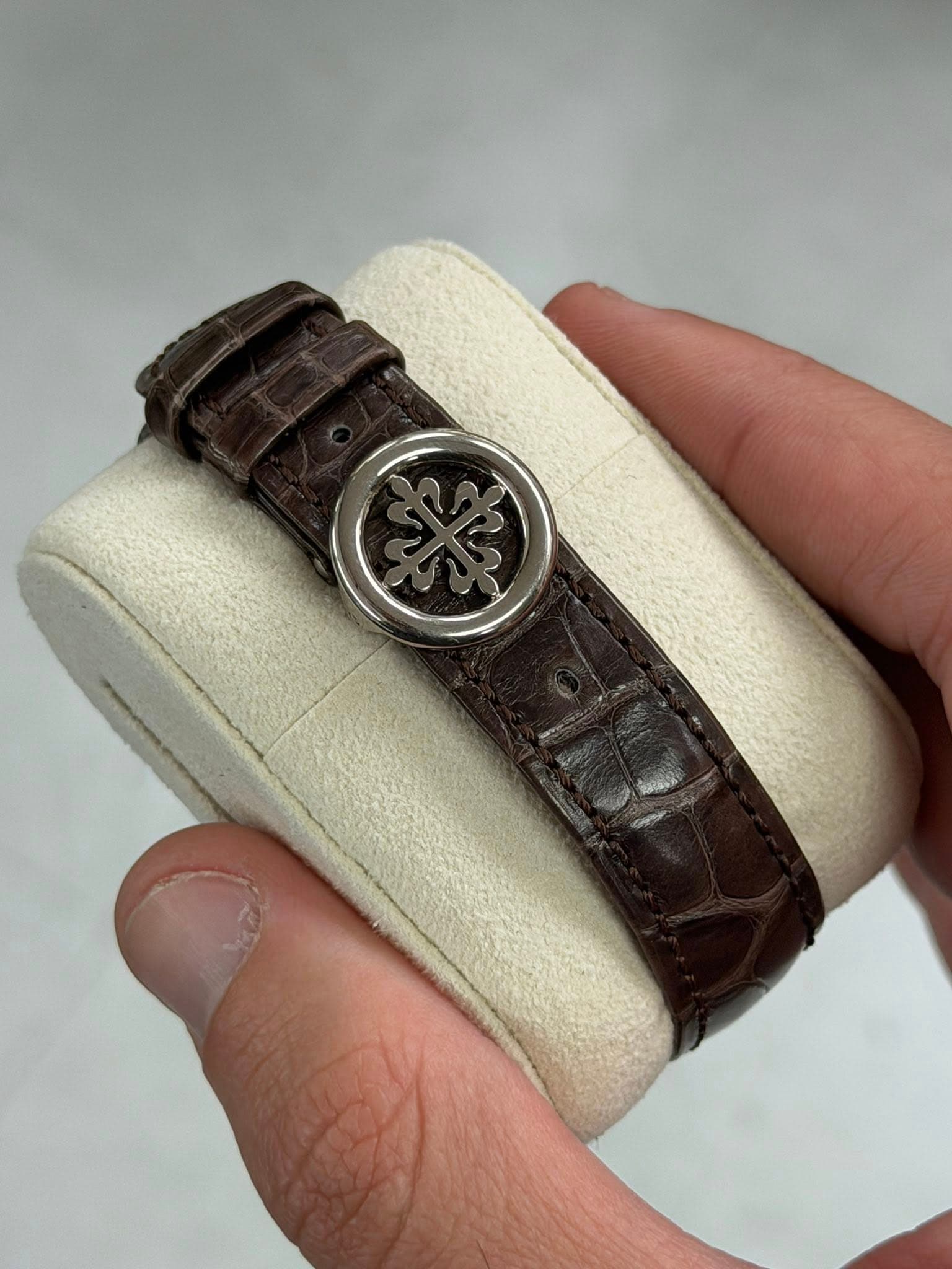 May be an image of wrist watch, leather and text