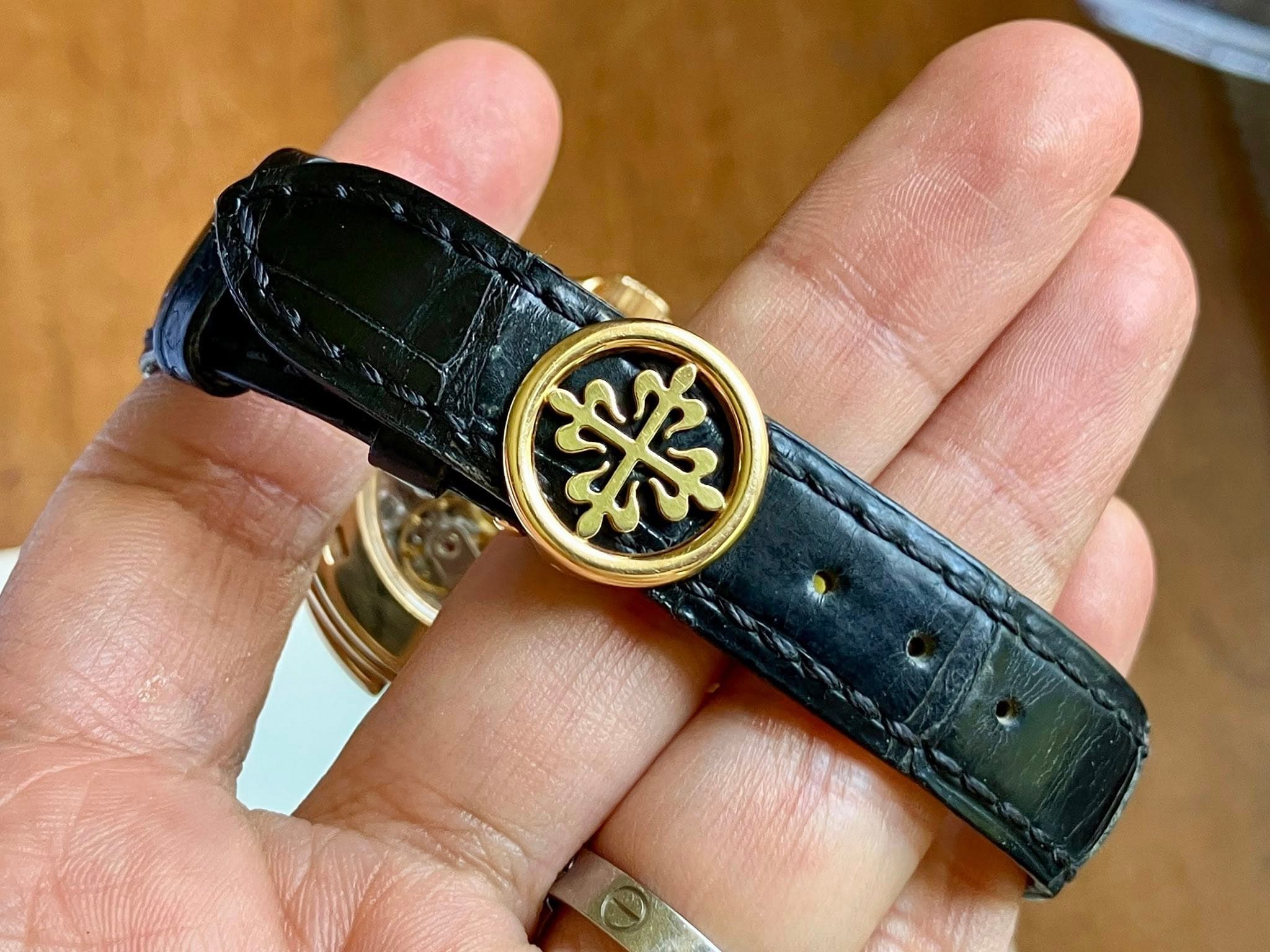 May be an image of leather, wrist watch and saddle-stitched leather