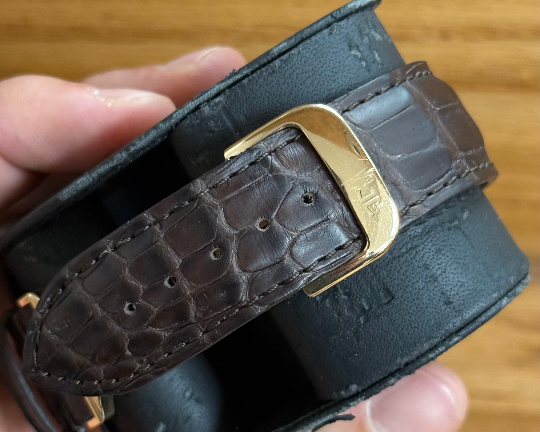 May be an image of leather, wrist watch and saddle-stitched leather
