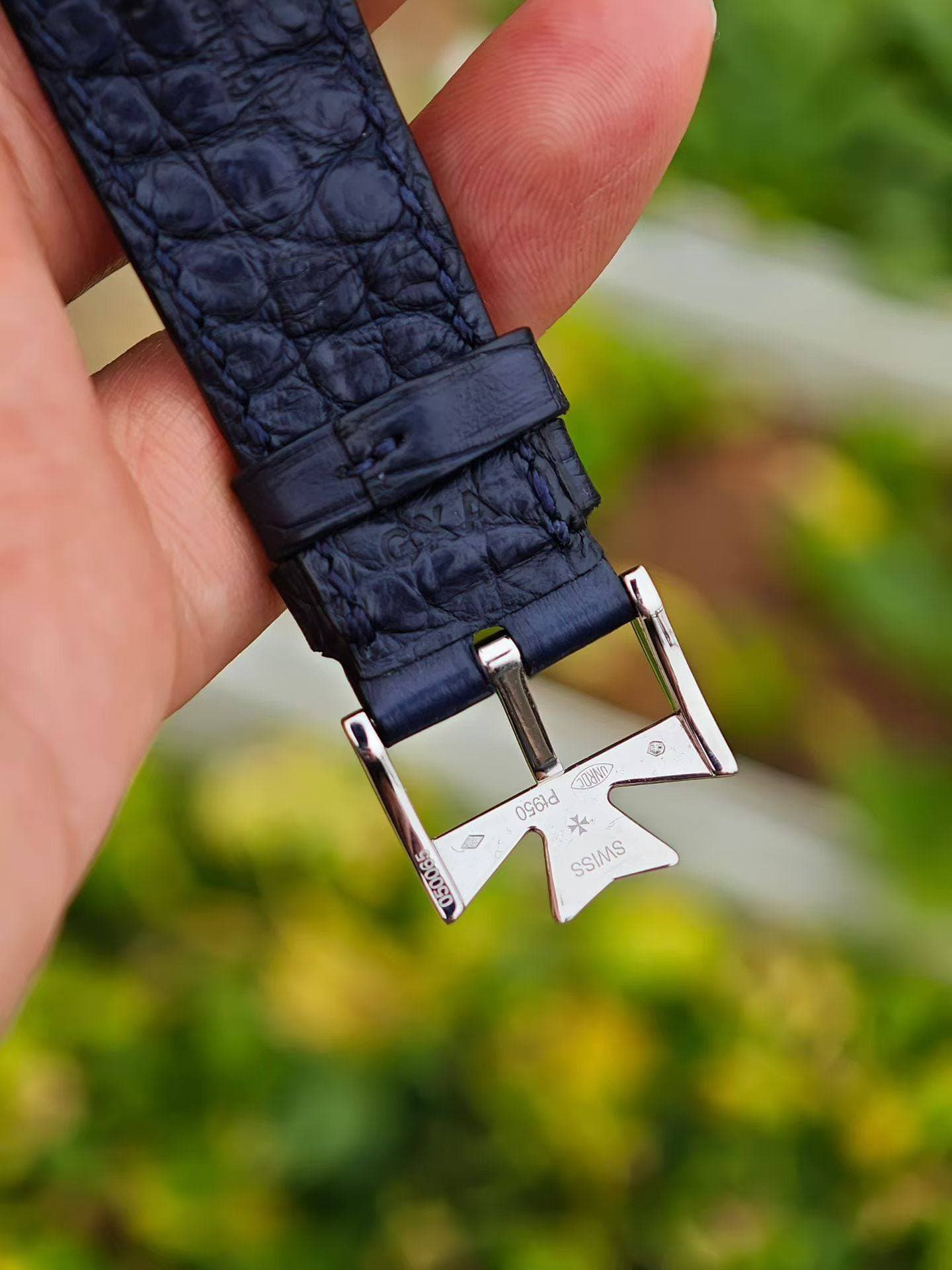May be an image of saddle-stitched leather, wrist watch, leather and text