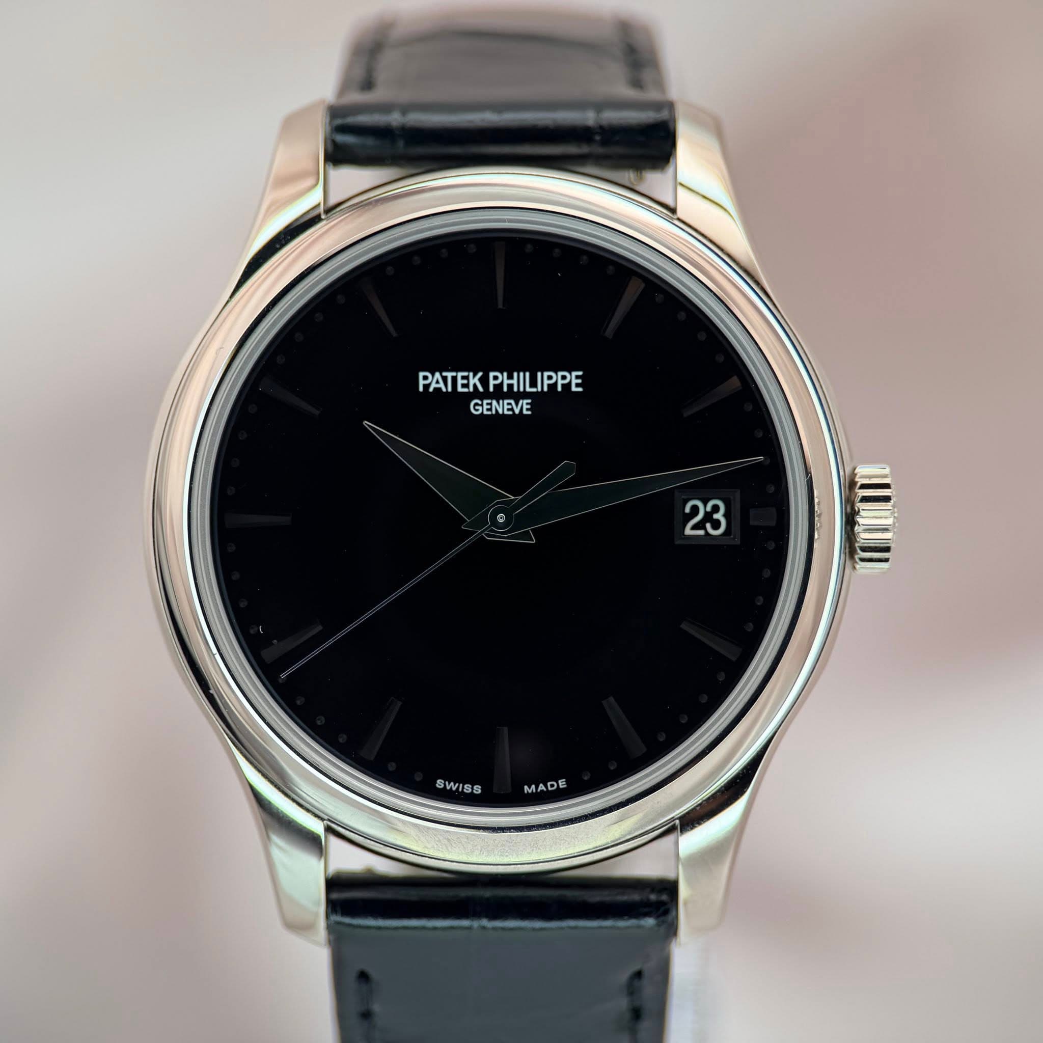 May be an image of wrist watch and text that says 'PATEK PATEKPHILIPPE PHILIPPE GENEVE 23 23 SWISS MADE'