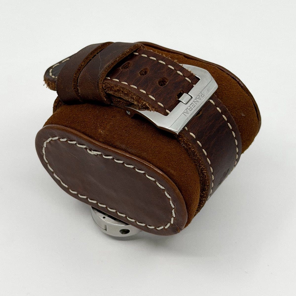May be an image of wrist watch, leather, saddle-stitched leather and text