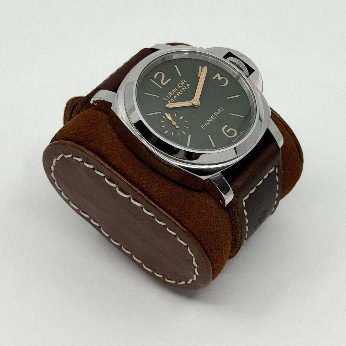 May be an image of wrist watch, saddle-stitched leather, leather and text