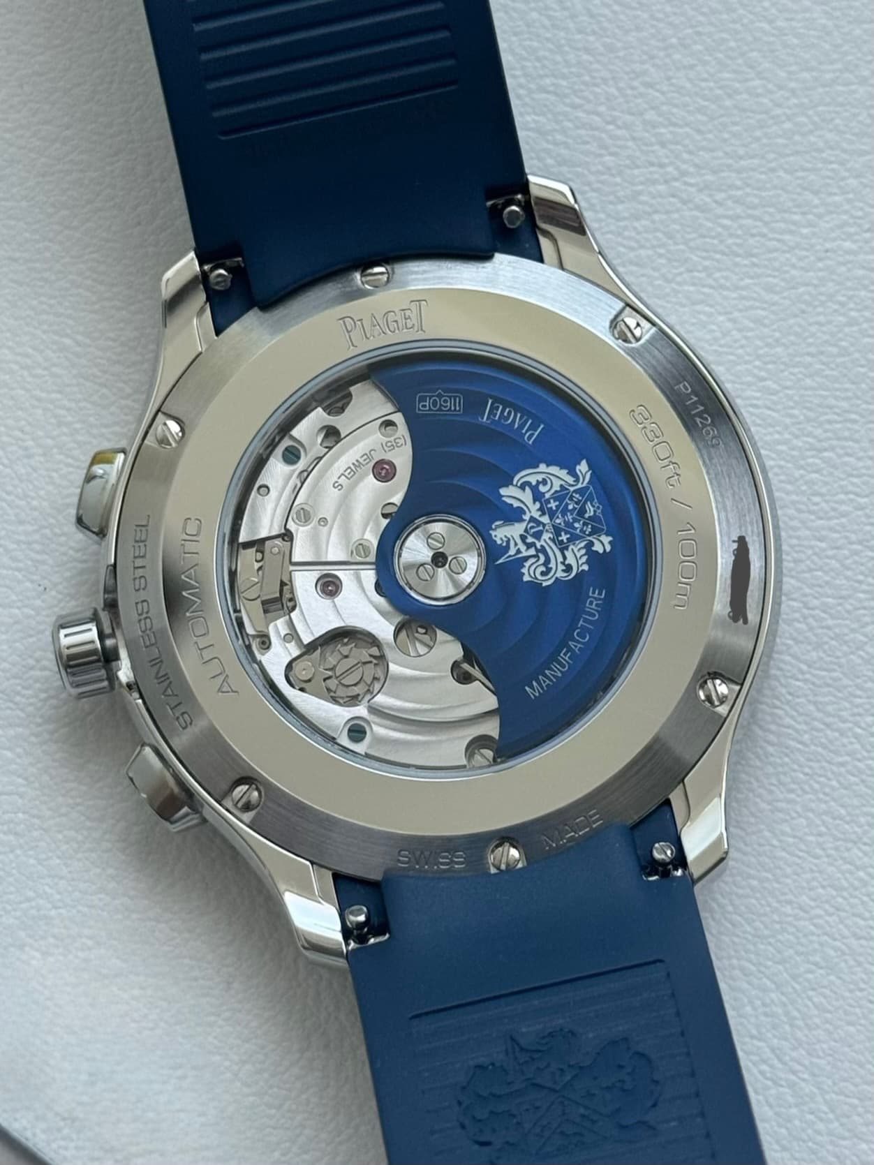 May be an image of wrist watch and text that says 'PIAGET 19 911 PerrEr PIIREL do SEEES (SE) 0 STEEL LESSSTEEL LESS AUTOMATIO ΓC II 3 P11269 100m 100m 100m و SWI.SE'