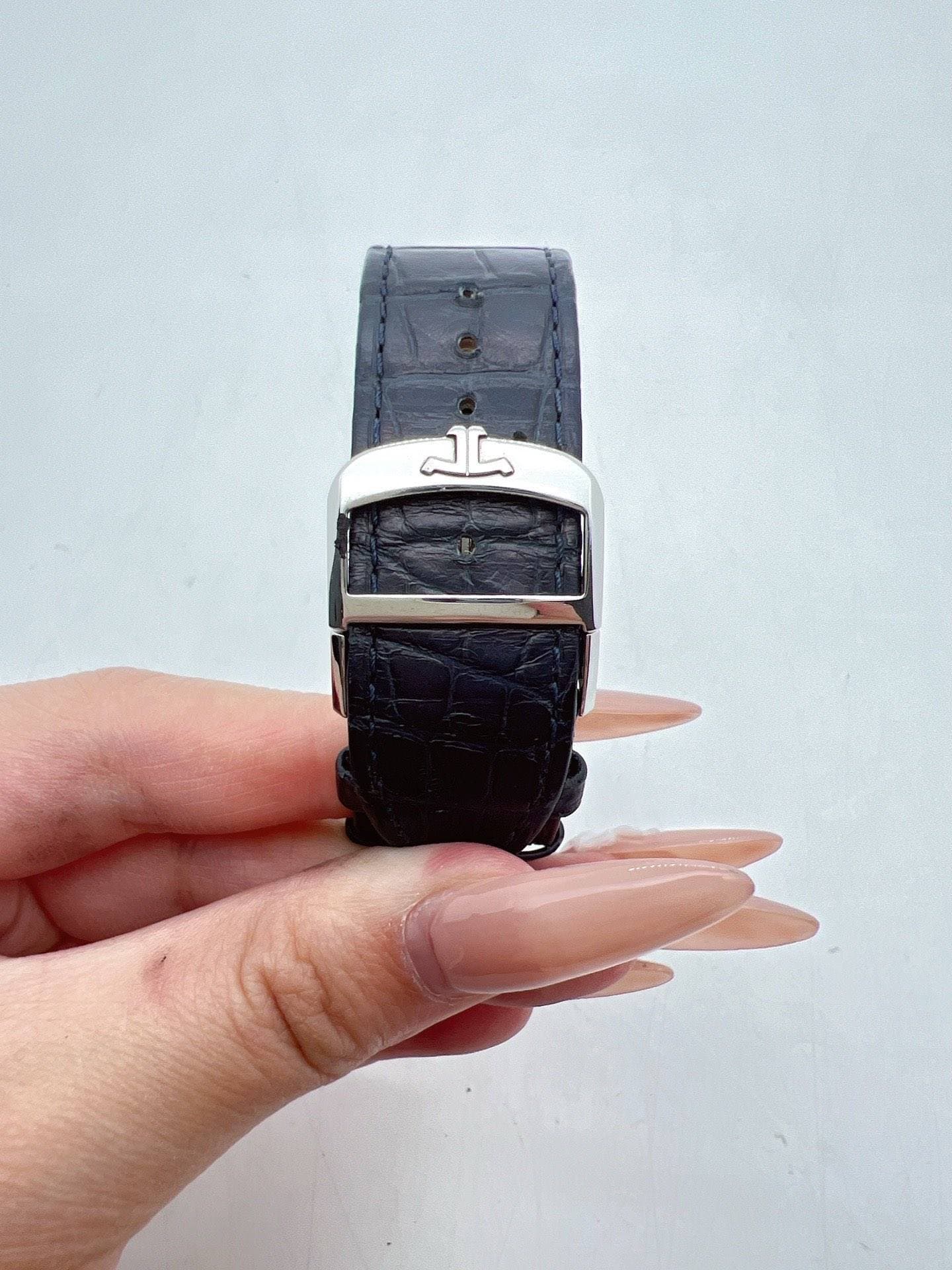 May be an image of digital watch, leather and text