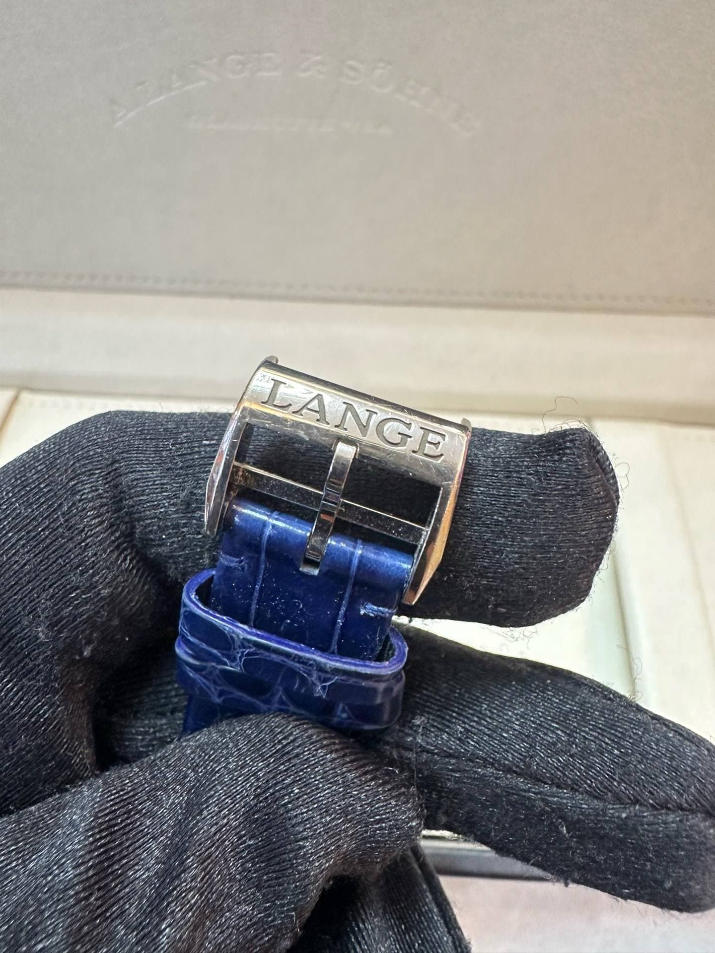 May be an image of wrist watch, ring and text that says 'LANGE N LANGE בו e'
